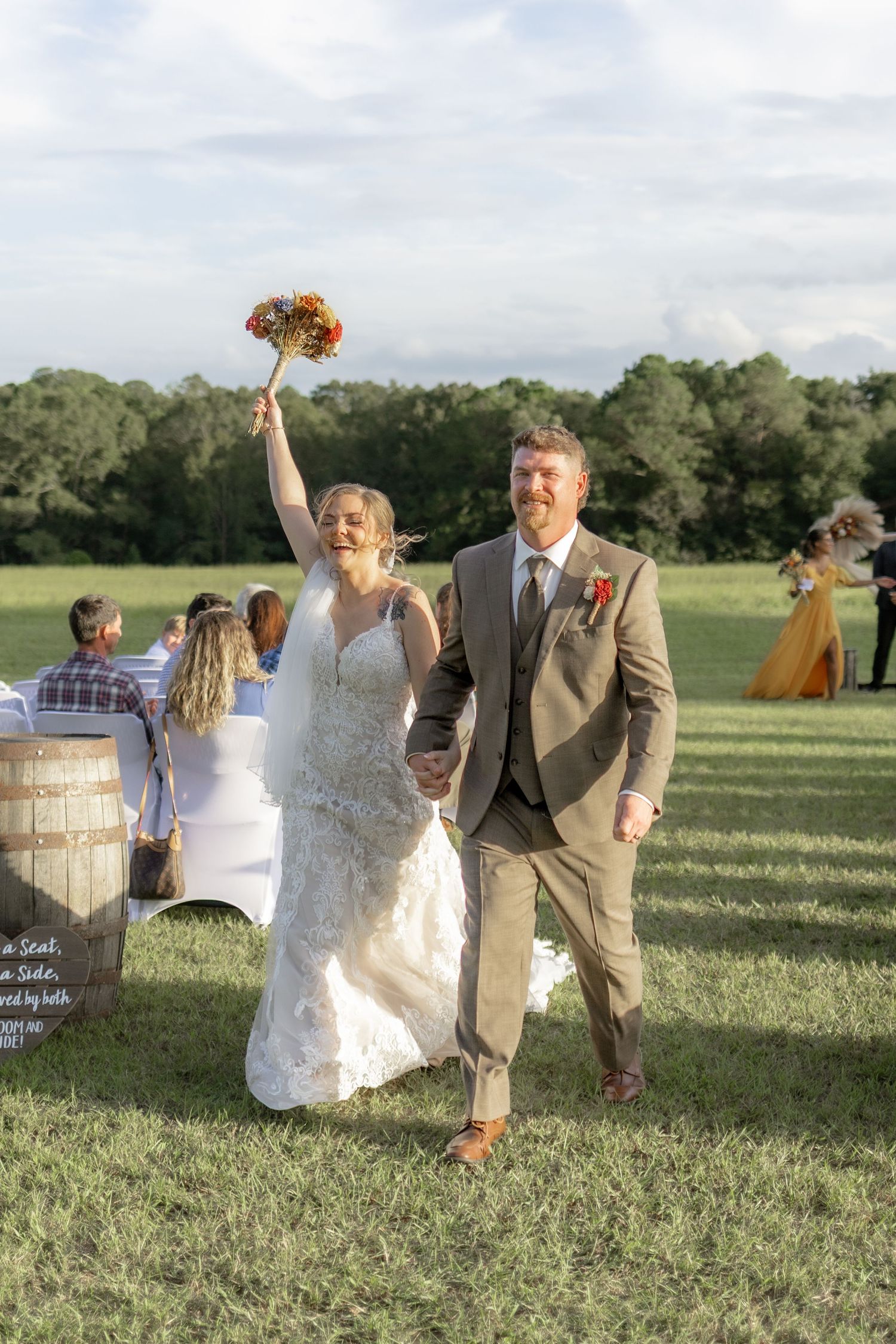 Bride and groom exiting their ceremony at Hilltop Acres Wicksburg, Alabama