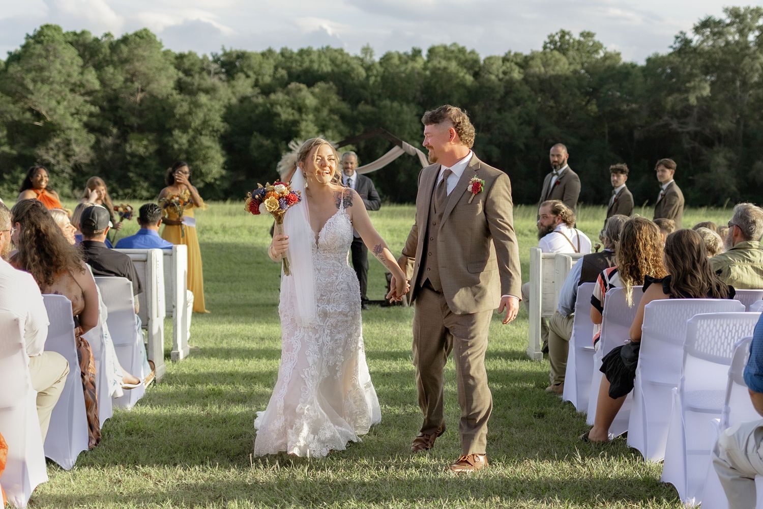 Bride and groom exiting their ceremony at Hilltop Acres Wicksburg, Alabama
