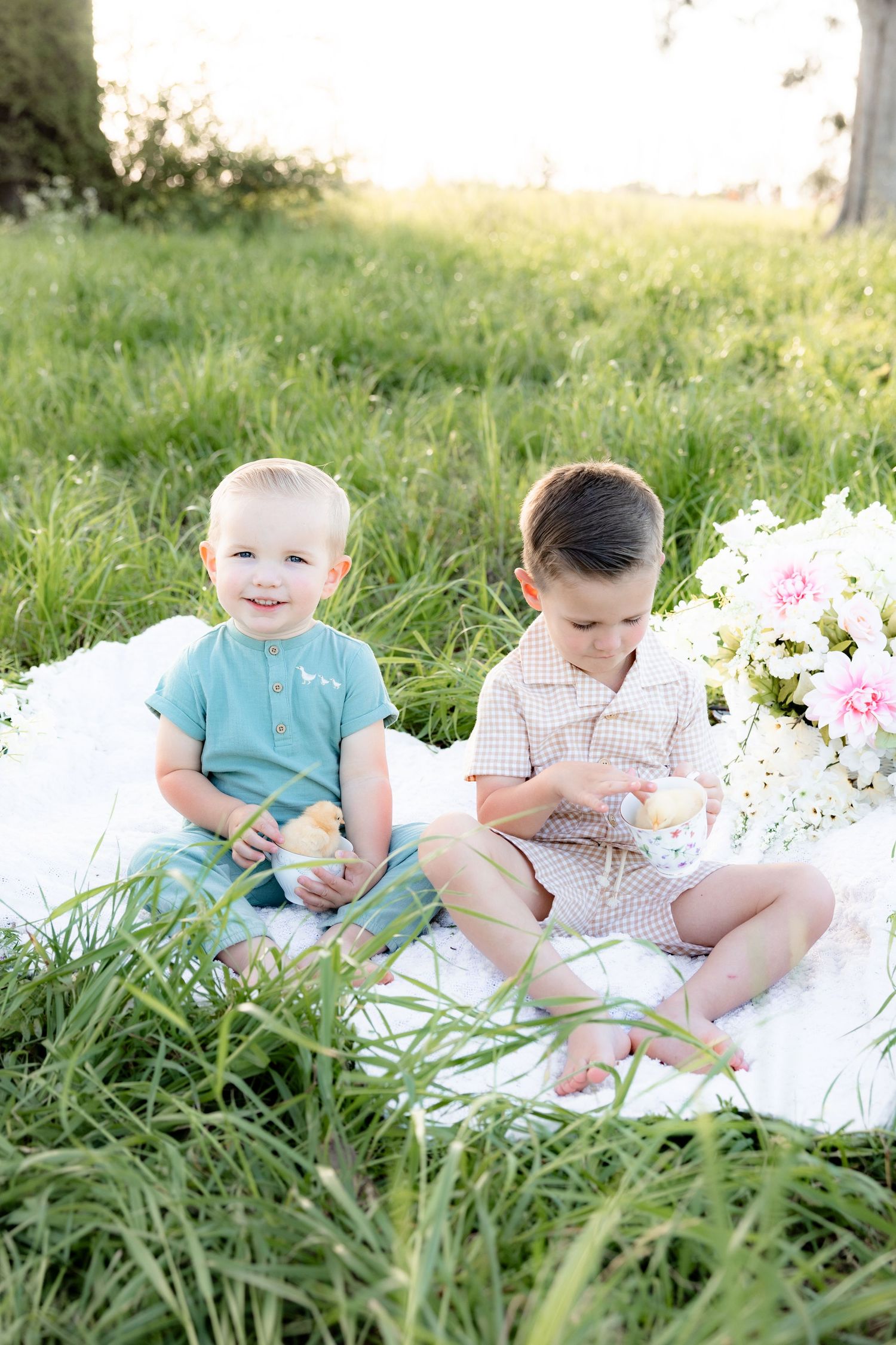 Spring Mini Session with baby chicks in a grass field at sunset near Dothan, Alabama