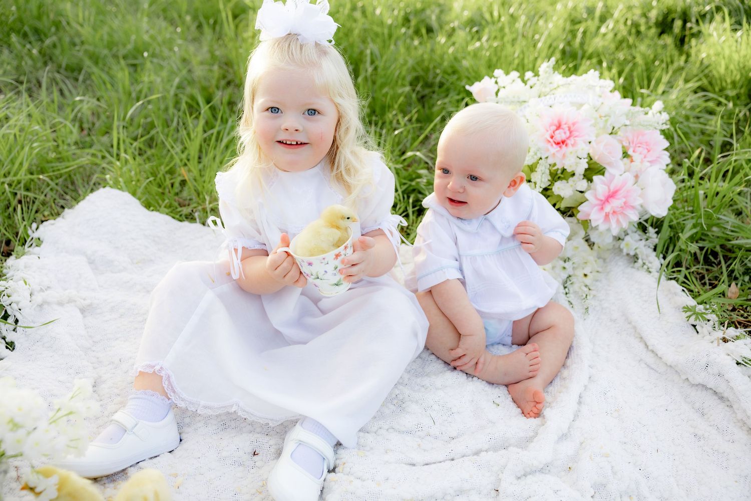 Spring Mini Session with baby chicks in a grass field at sunset near Dothan, Alabama