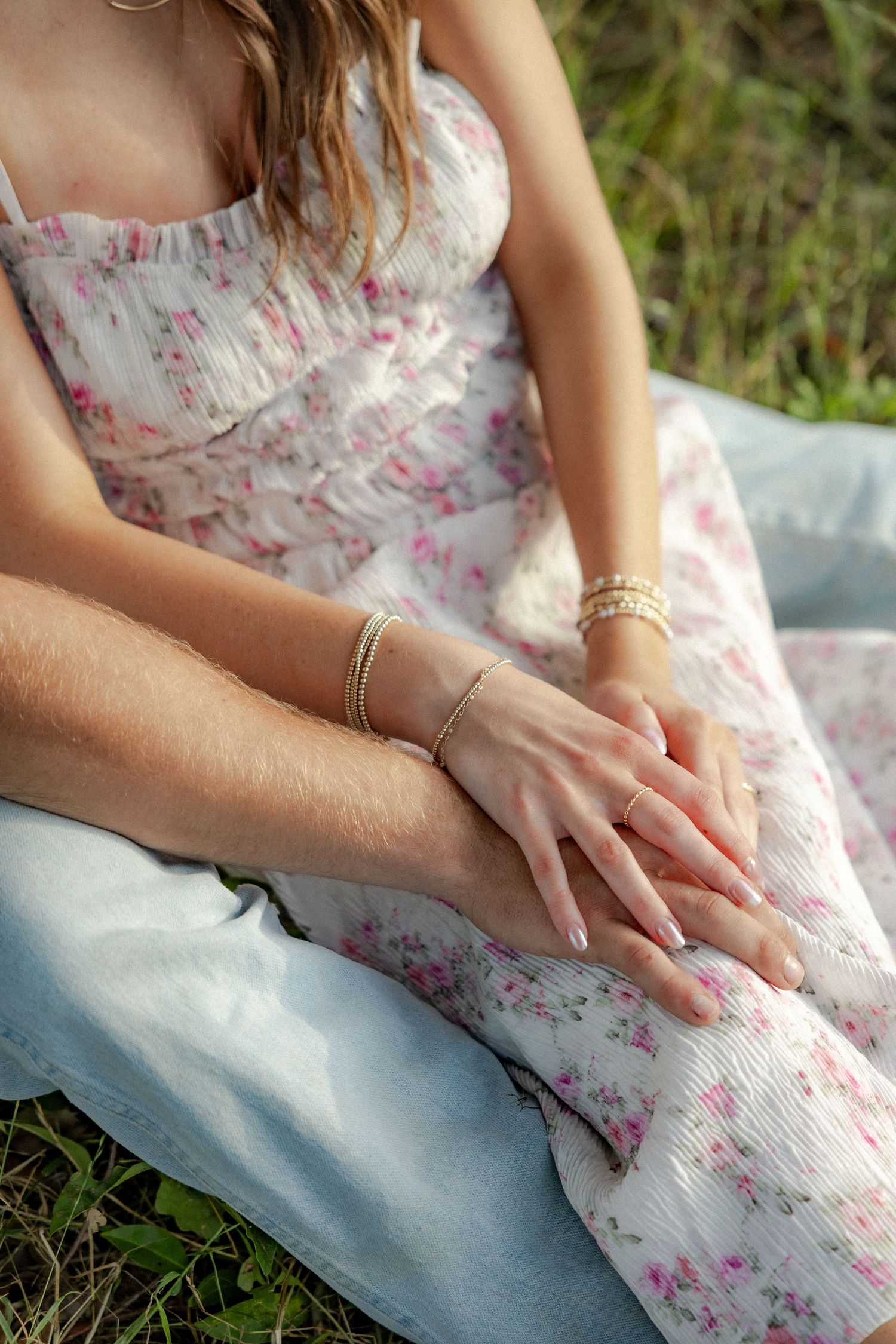 Romantic couple photos in a natural grass field setting with large trees at sunset.