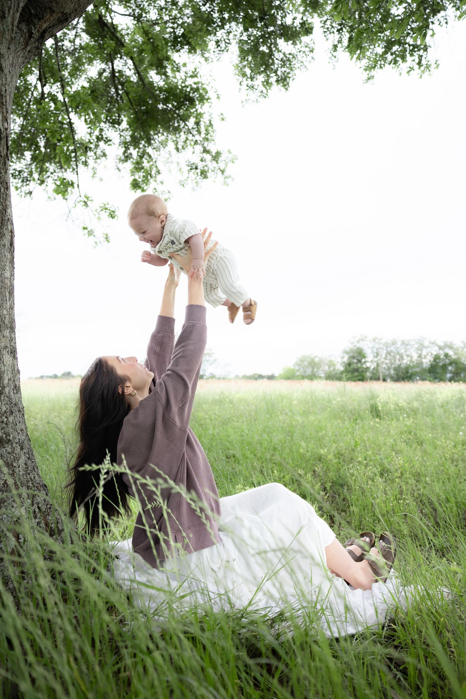 Candid family photos in a grass field | Dothan, Alabama Lifestyle Portrait Photographer