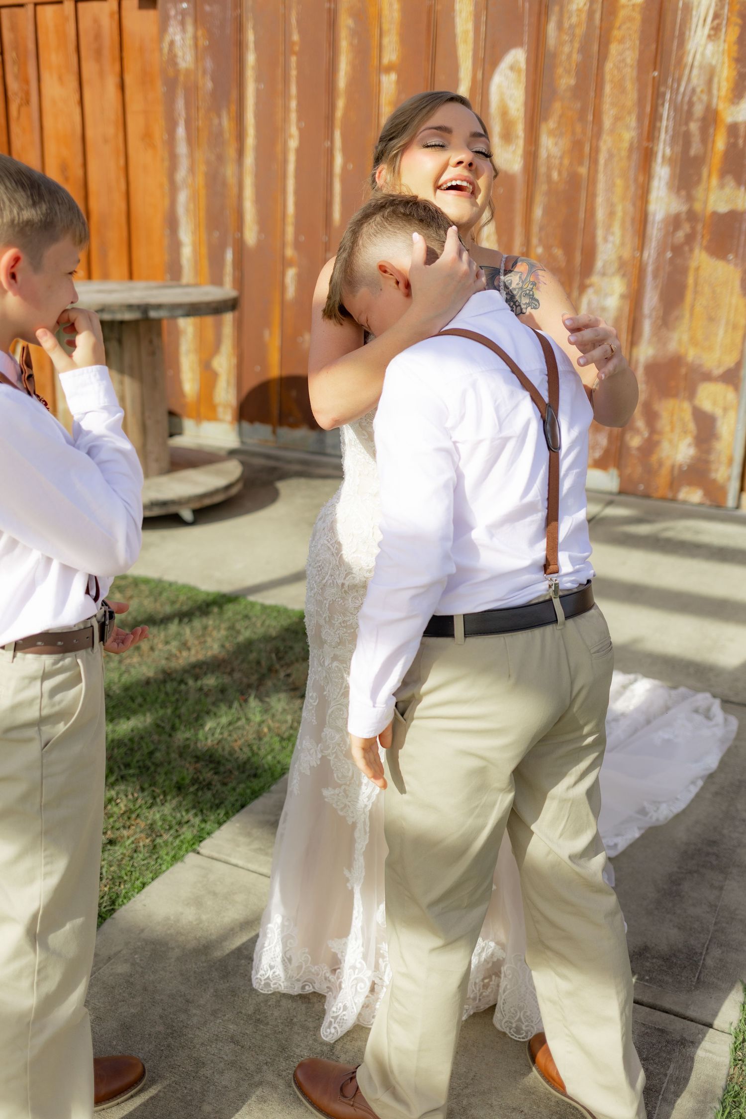 Sons' first look with bride underneath the gazebo at Hilltop Acres Wicksburg, Alabama