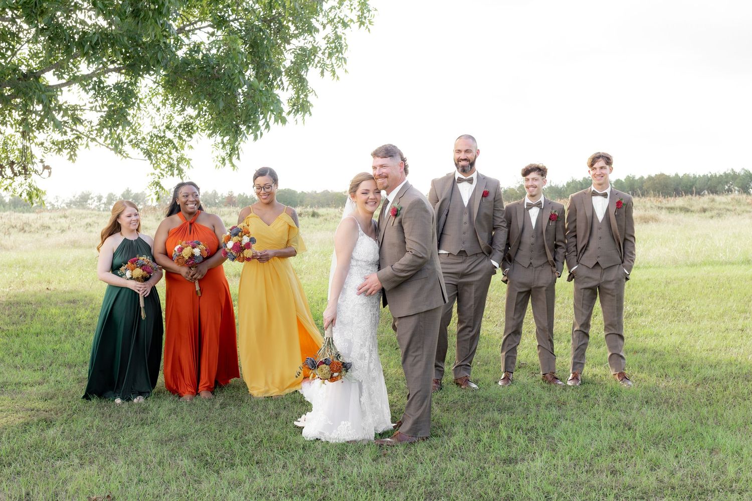 Bridal party posing in a field at sunset at Hilltop Acres Wicksburg, Alabama