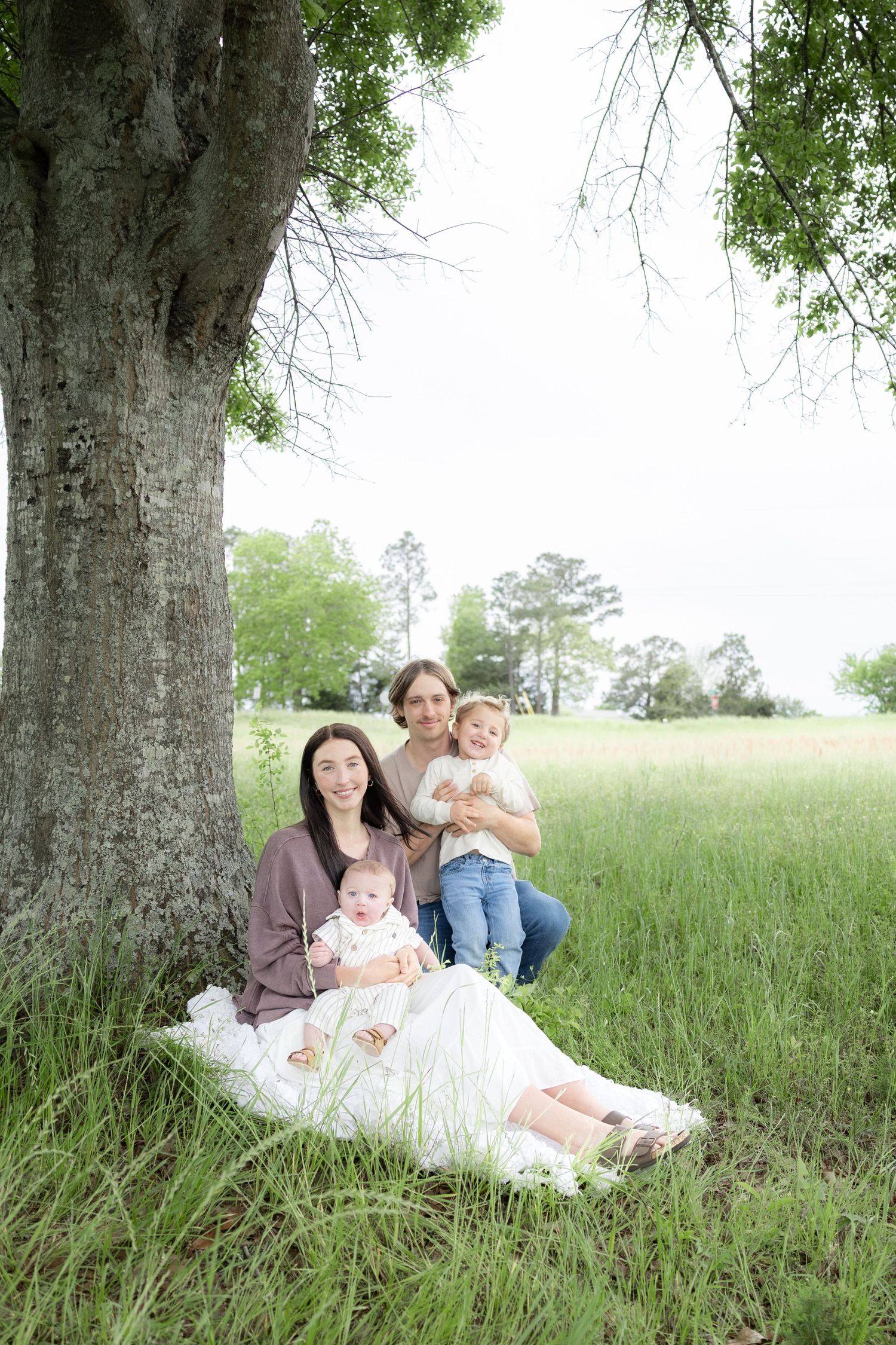 Candid family photos in a grass field | Dothan, Alabama Lifestyle Portrait Photographer