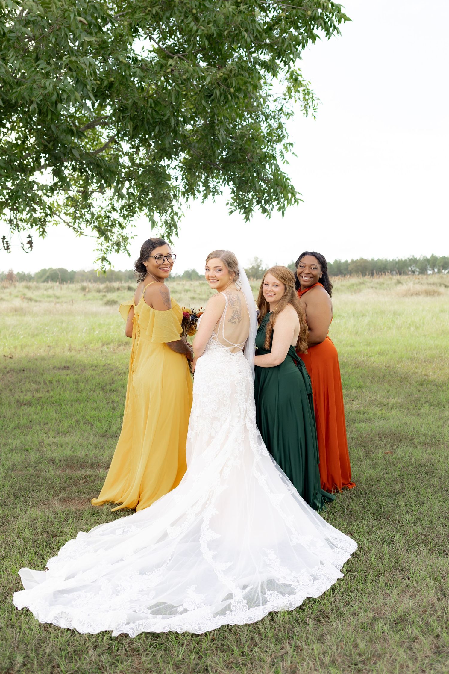 Bridal party posing in a field at sunset at Hilltop Acres Wicksburg, Alabama