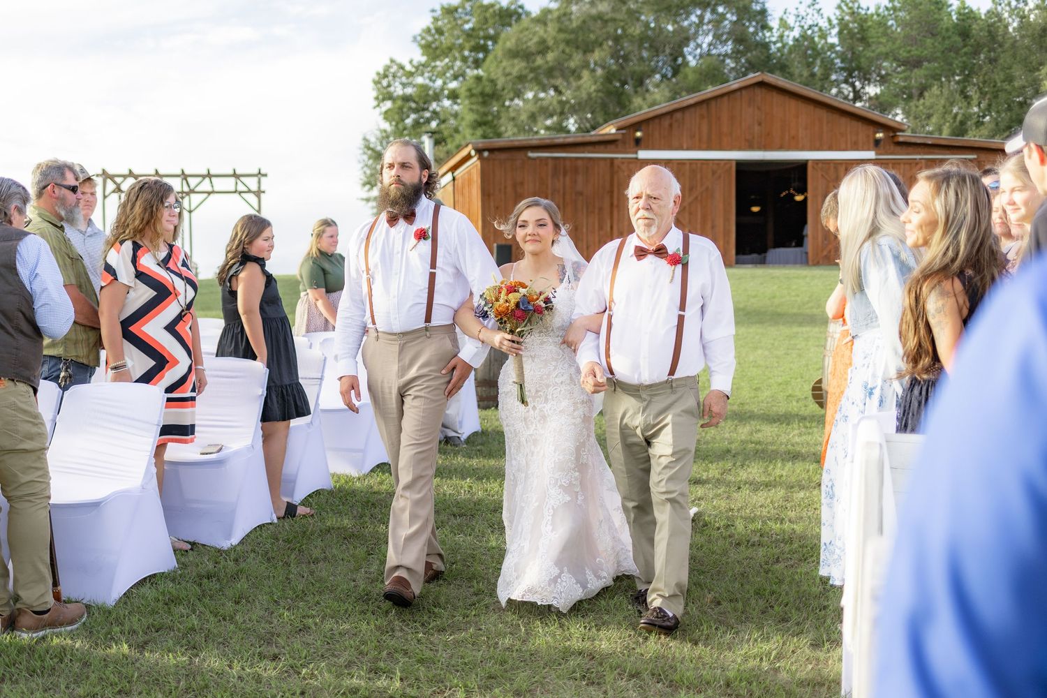 Father and brother giving the bride away at a wedding at Hilltop Acres Wicksburg, Alabama