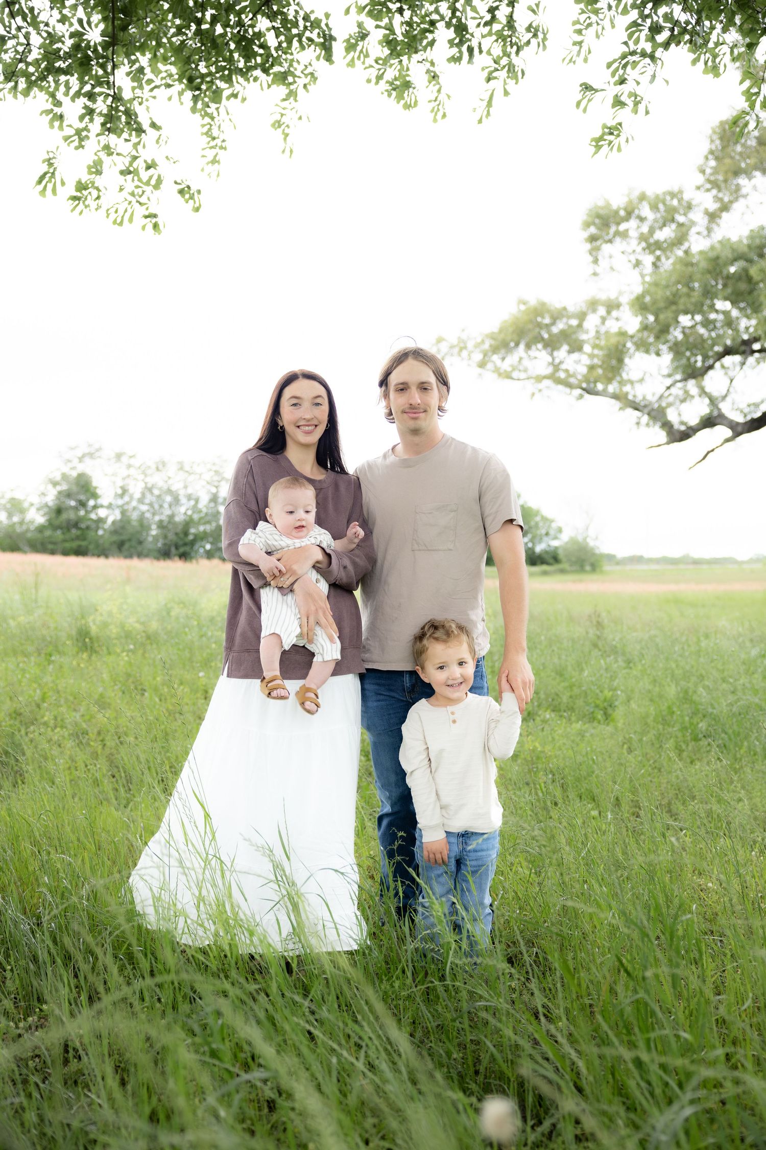 Candid family photos in a grass field | Dothan, Alabama Lifestyle Portrait Photographer