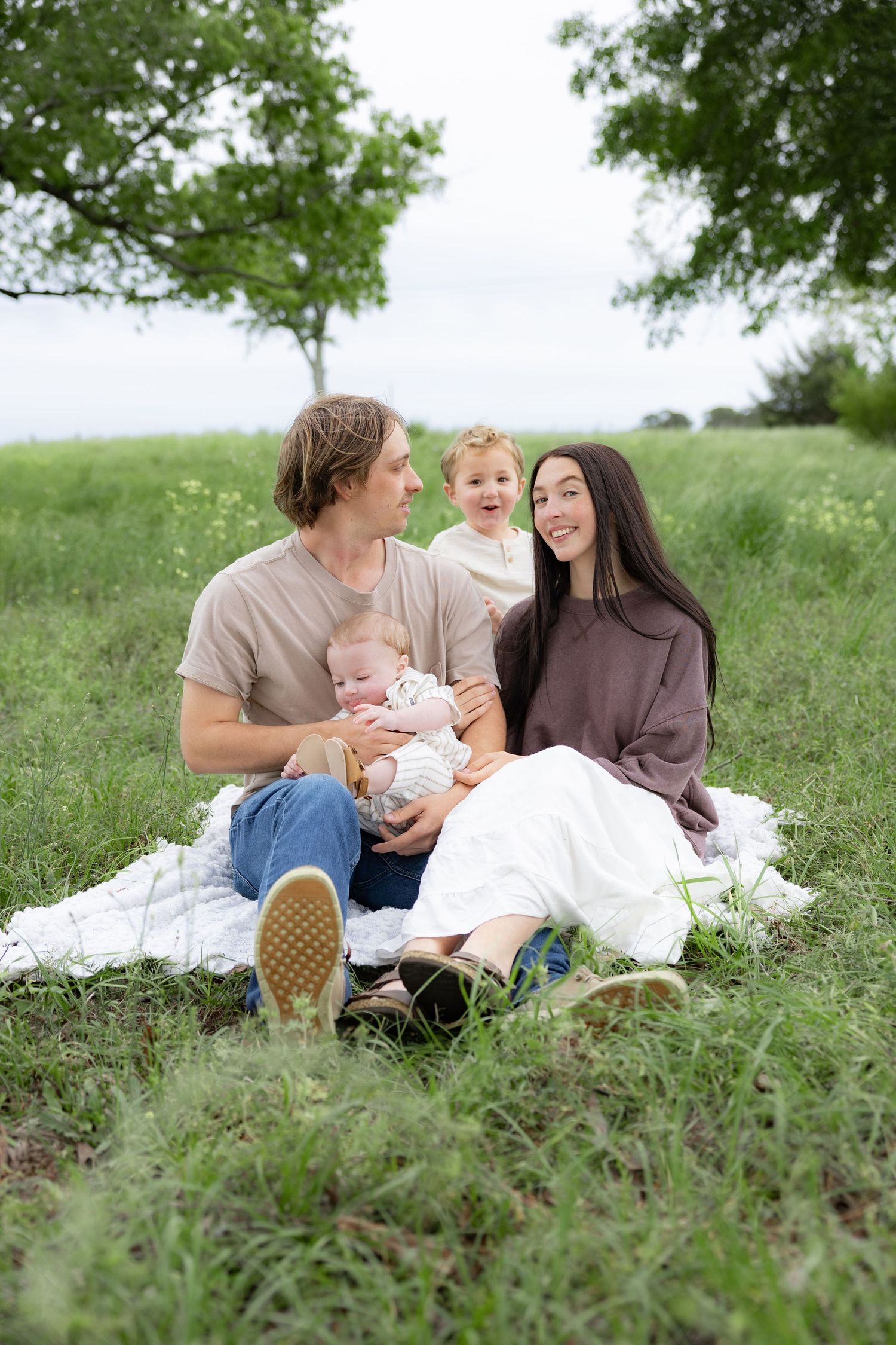 Candid family photos in a grass field | Dothan, Alabama Lifestyle Portrait Photographer