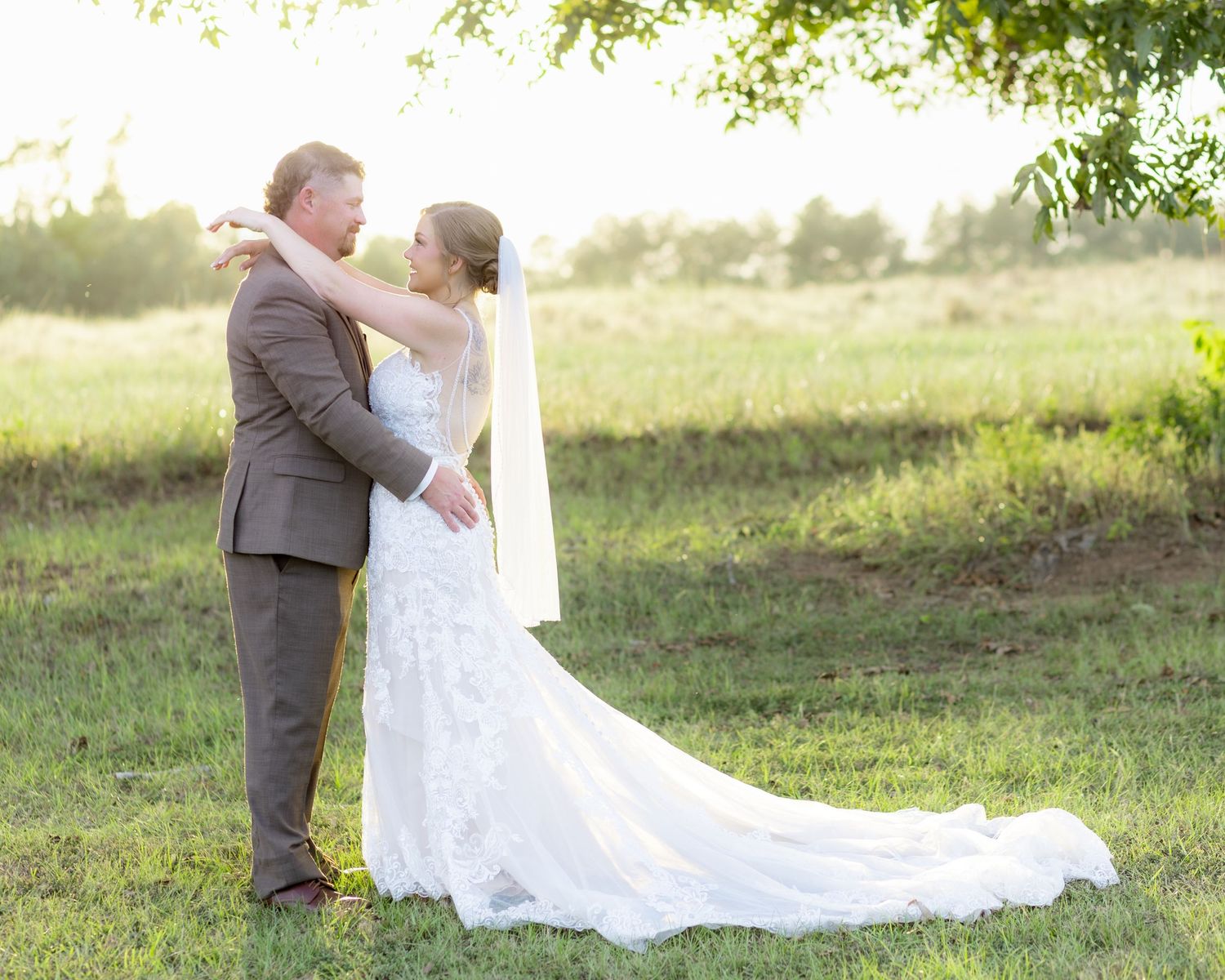 Bride and groom hold each other at sunset at Hilltop Acres Wicksburg, Alabama