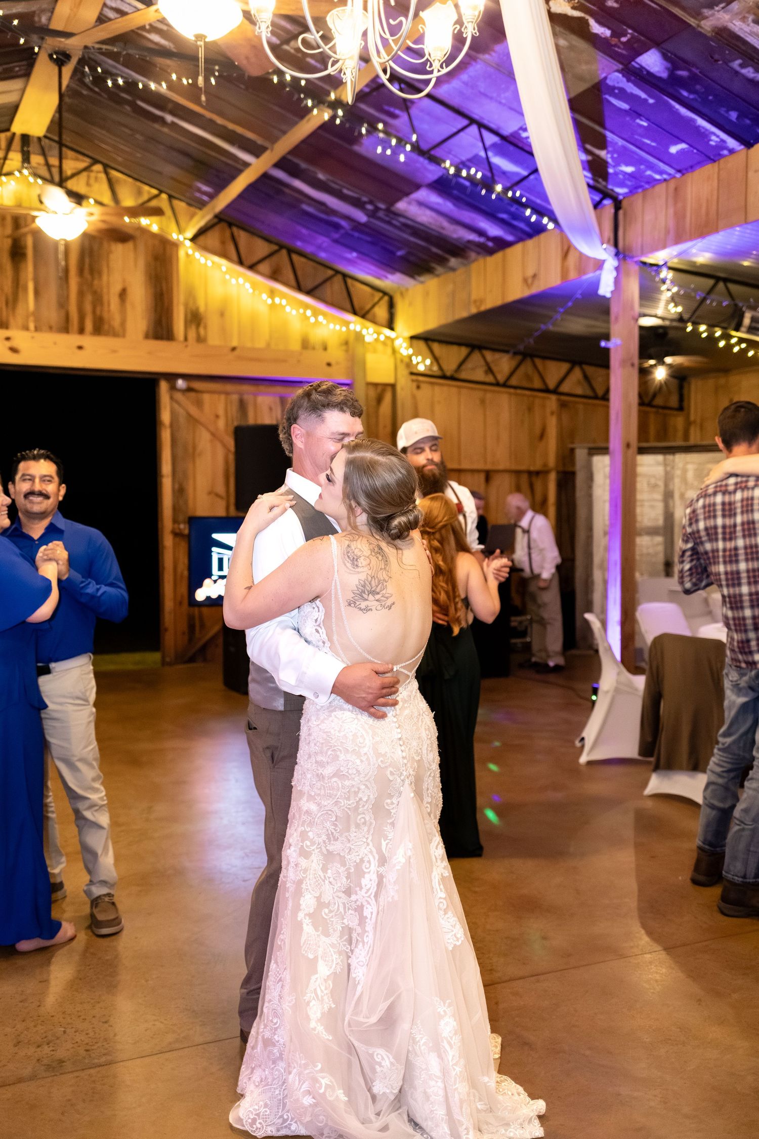Bride and groom dancing at their wedding in the barn of Hilltop Acres Wicksburg, Alabama