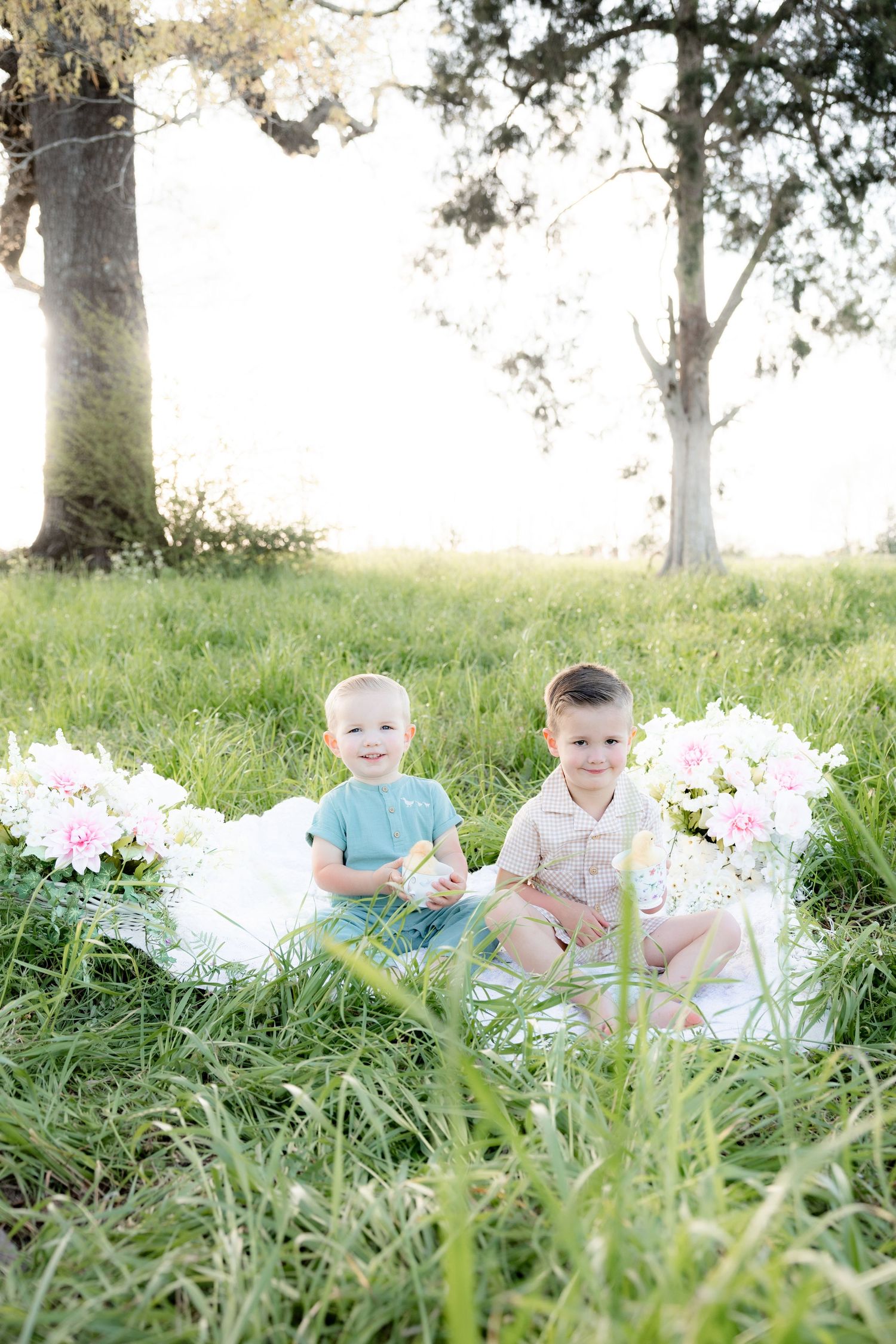 Spring Mini Session with baby chicks in a grass field at sunset near Dothan, Alabama