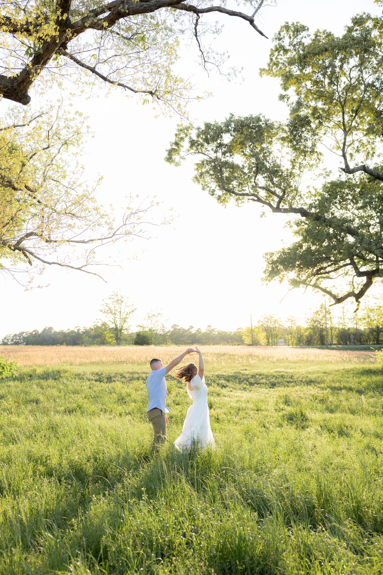 Storytelling couple photos in a tall grass field at sunset in Dothan, Alabama