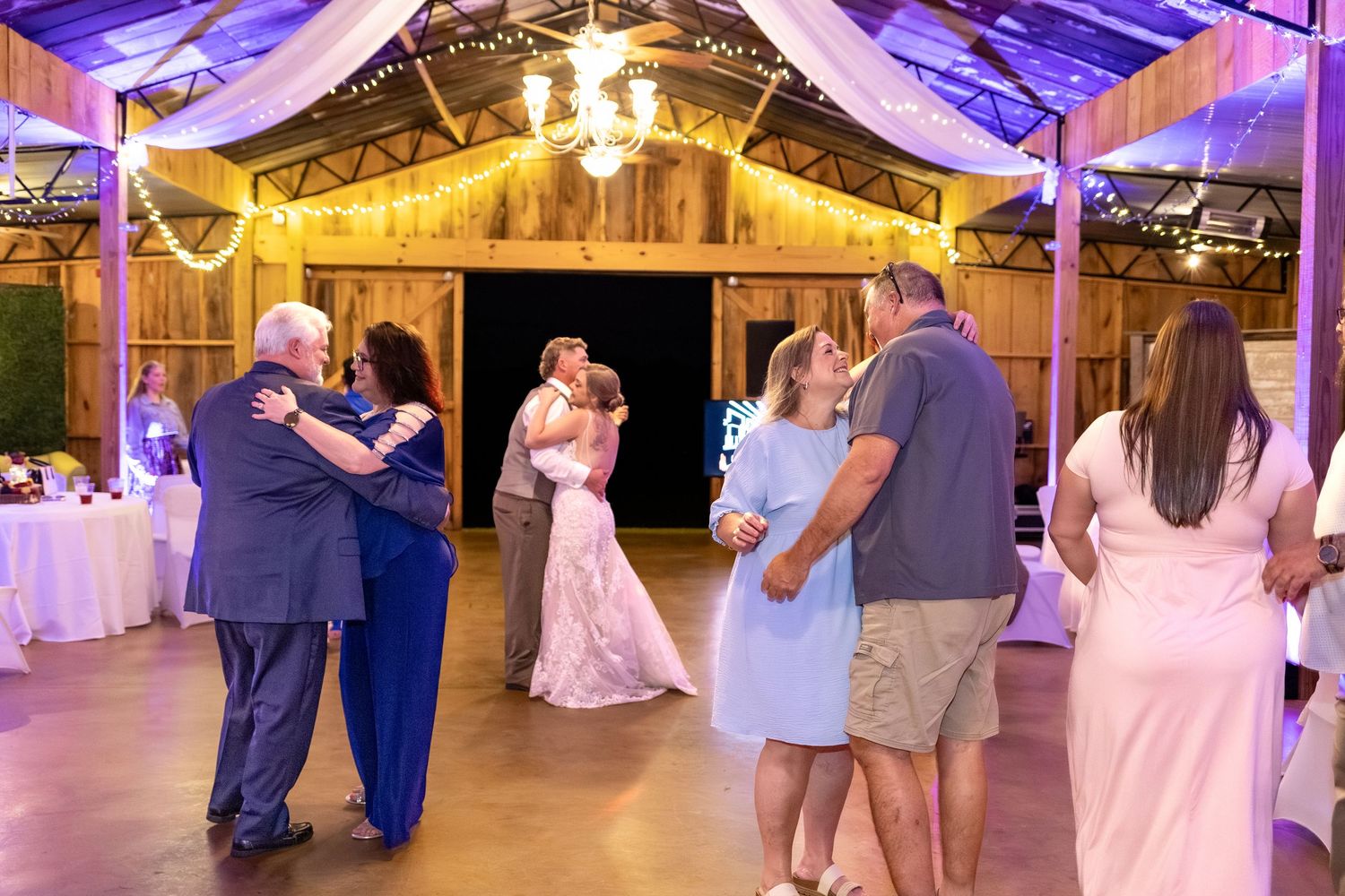 Bride and groom dancing at their wedding in the barn of Hilltop Acres Wicksburg, Alabama
