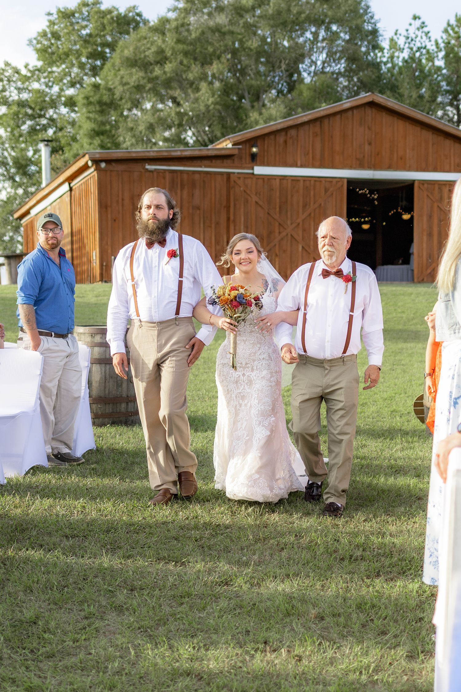 Father and brother giving the bride away at a wedding at Hilltop Acres Wicksburg, Alabama