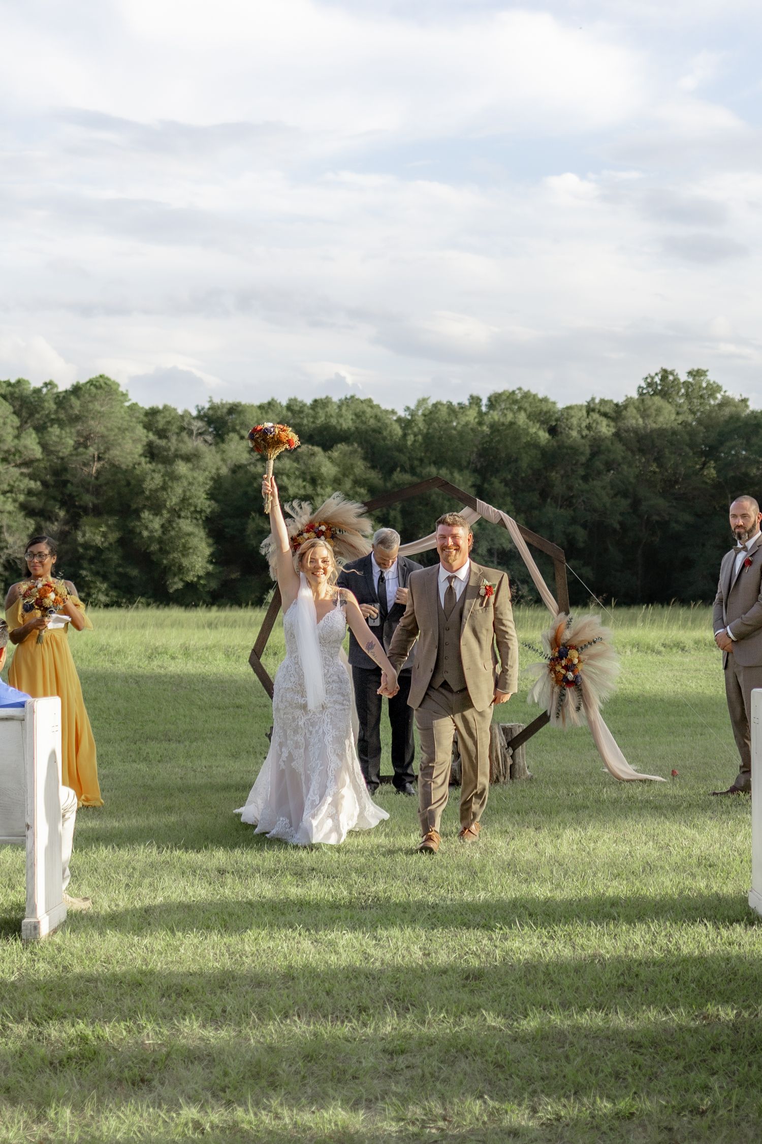 Bride and groom exiting their ceremony at Hilltop Acres Wicksburg, Alabama