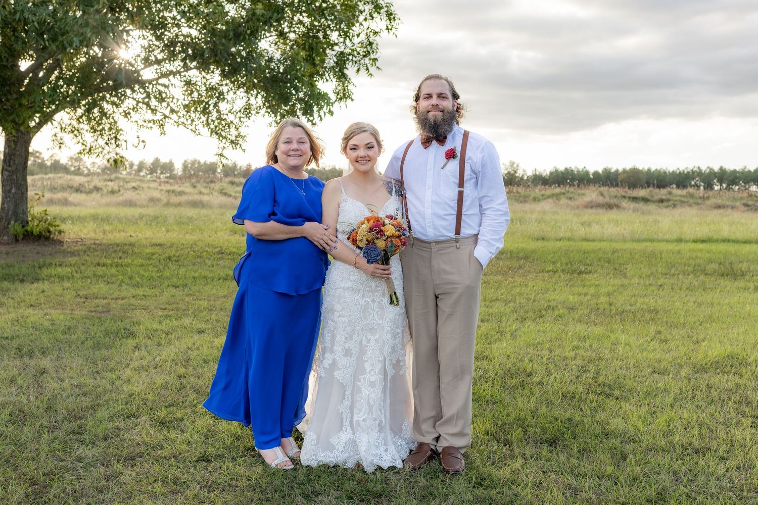 Bride, mother, and brother posing for a photo at Hilltop Acres Wicksburg, Alabama