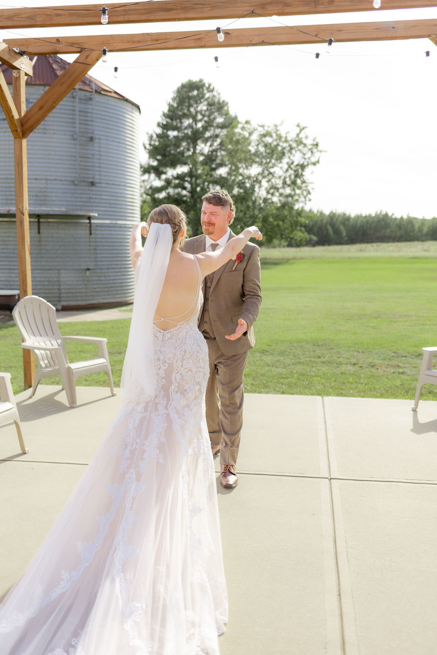 Groom first look with bride underneath the gazebo at Hilltop Acres Wicksburg, Alabama