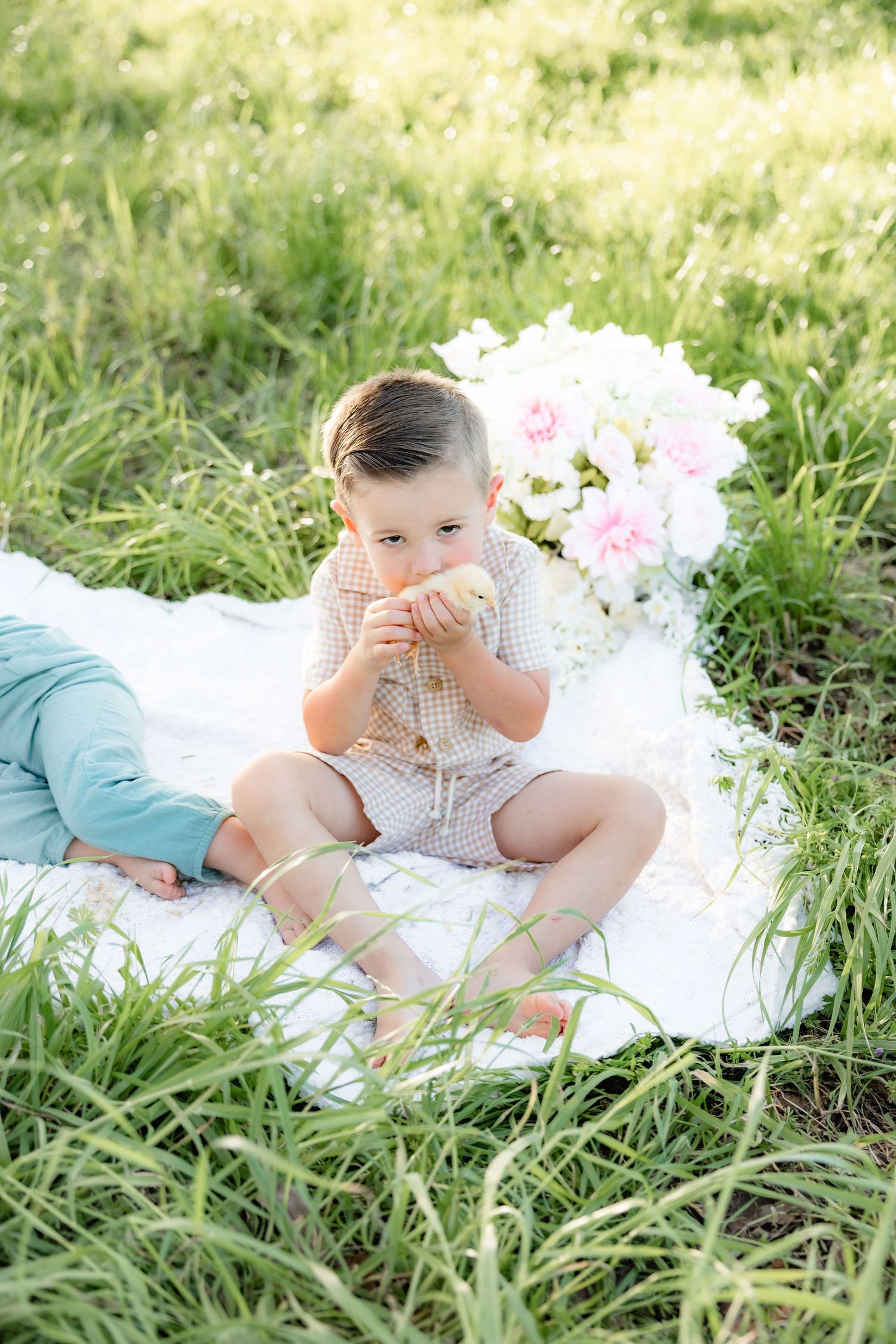 Spring Mini Session with baby chicks in a grass field at sunset near Dothan, Alabama
