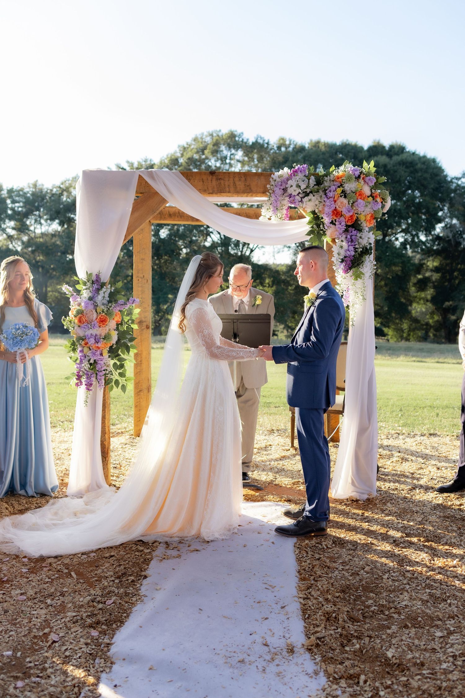 Couple getting married at the altar of Dalrymple Farms in Enterprise, Alabama