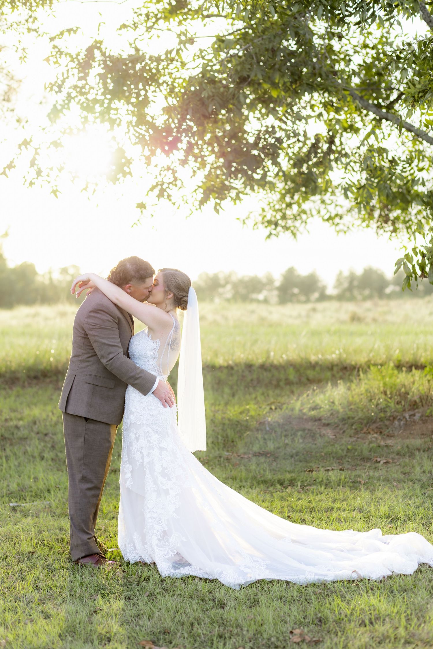 Bride and groom kiss at sunset at Hilltop Acres Wicksburg, Alabama