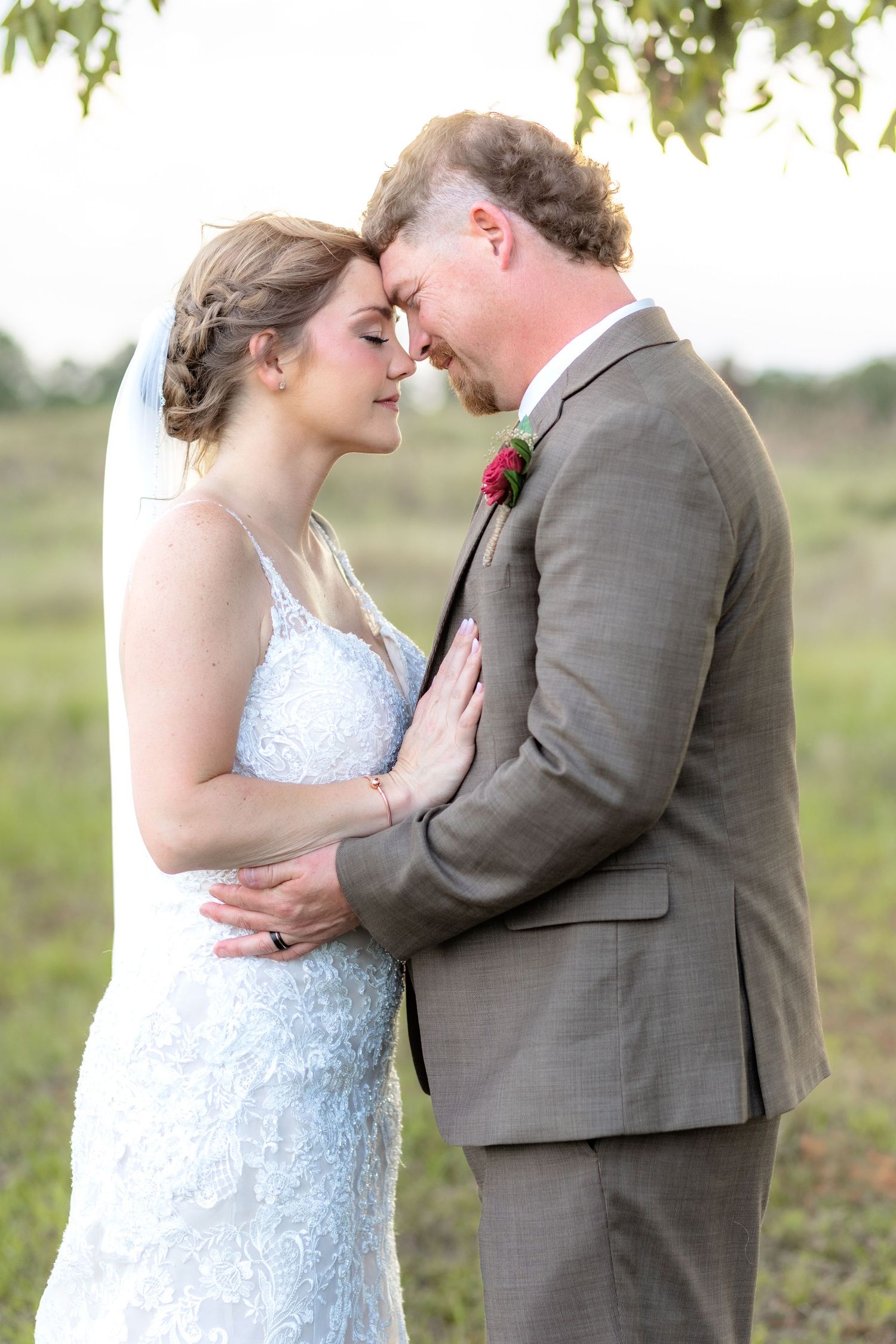 Bride and groom hold each other at sunset at Hilltop Acres Wicksburg, Alabama