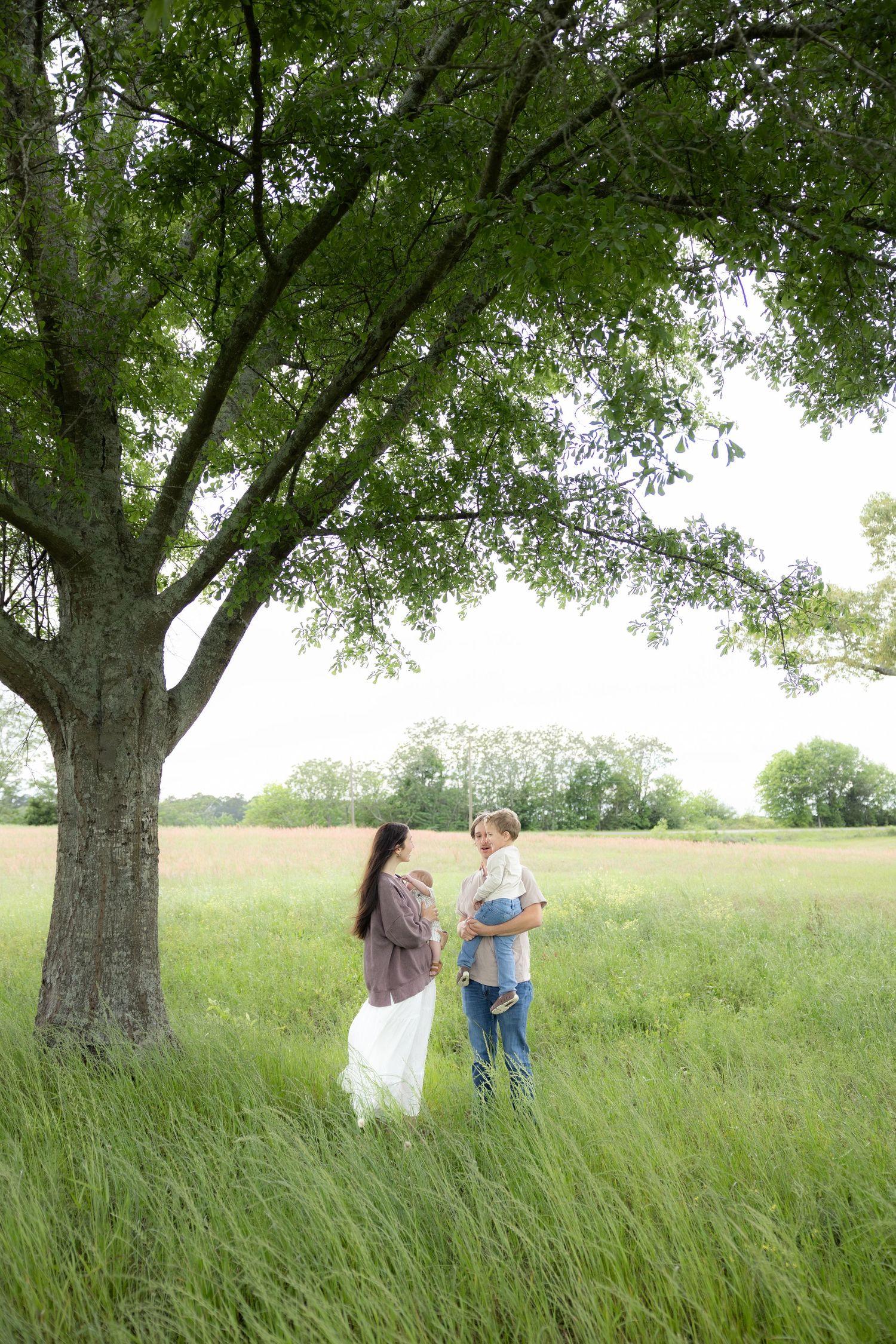 Candid family photos in a grass field | Dothan, Alabama Lifestyle Portrait Photographer