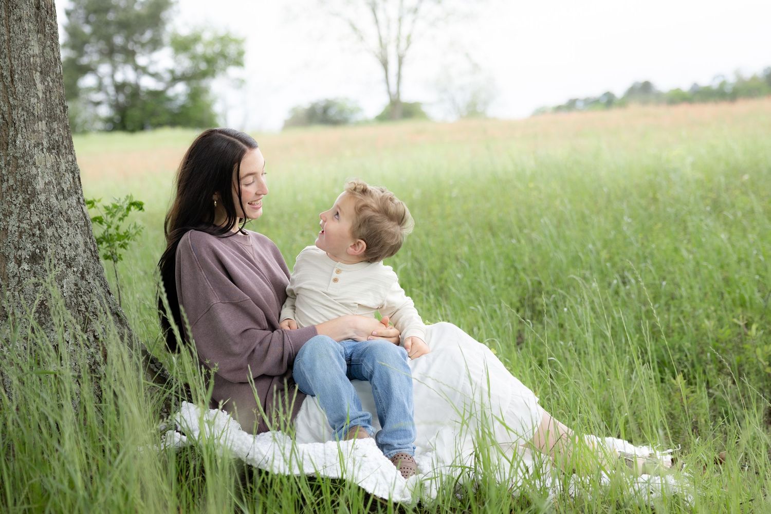 Candid family photos in a grass field | Dothan, Alabama Lifestyle Portrait Photographer