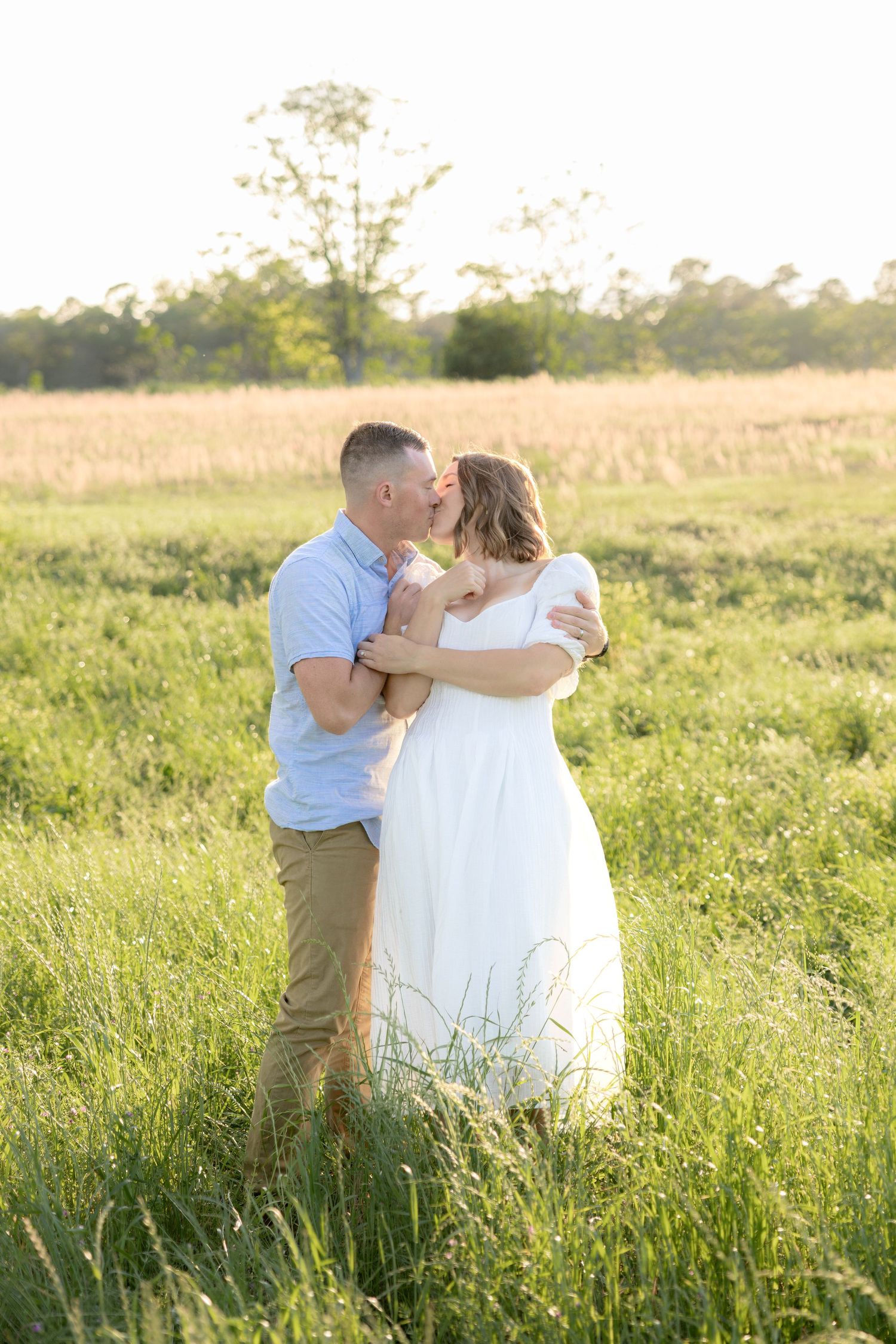 Storytelling couple photos in a tall grass field at sunset in Dothan, Alabama