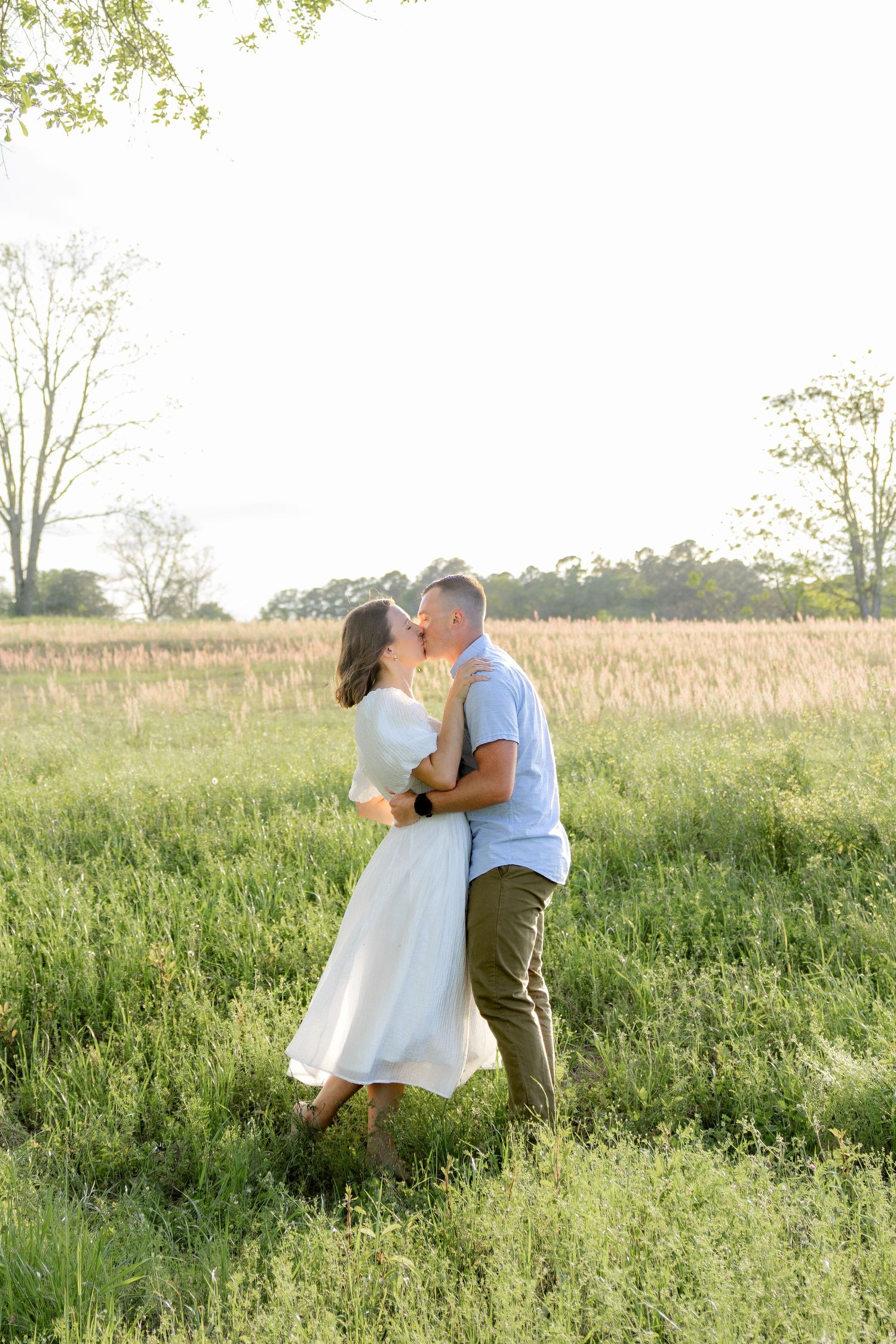 Storytelling couple photos in a tall grass field at sunset in Dothan, Alabama