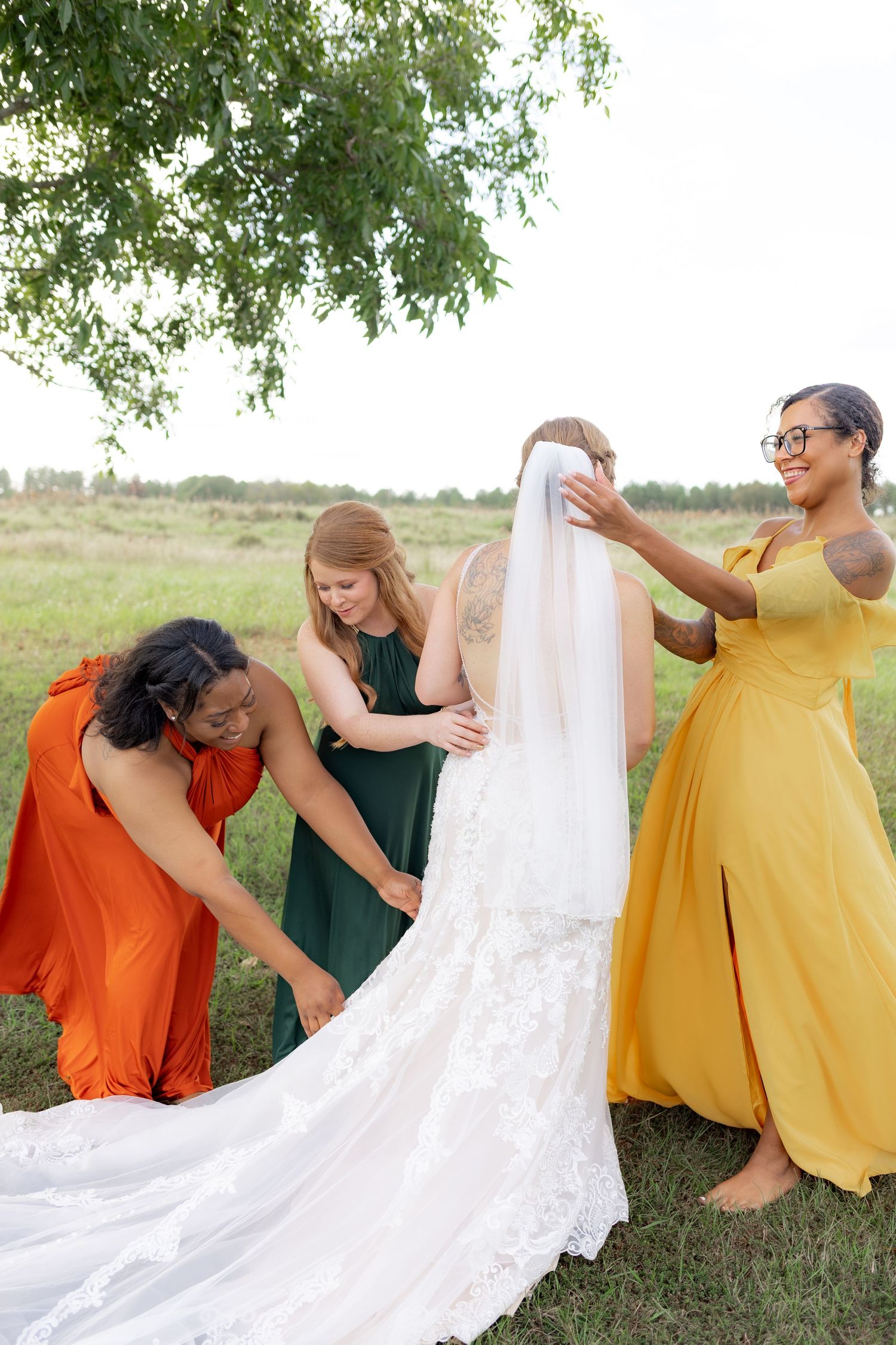 Bridal party posing in a field at sunset at Hilltop Acres Wicksburg, Alabama