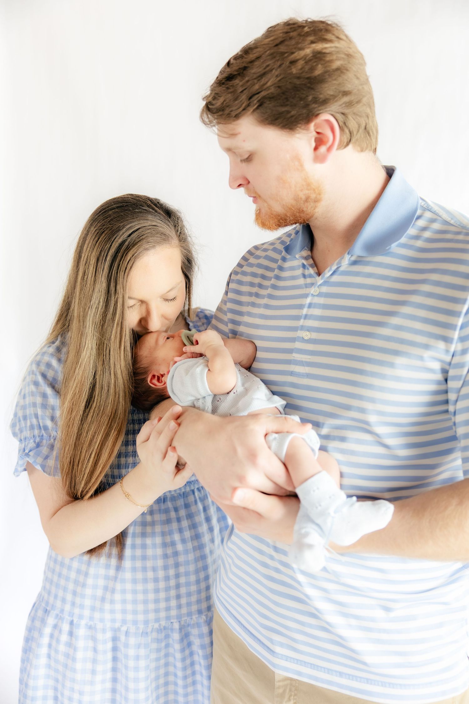 Family holding their baby in a studio in Dothan, Alabama