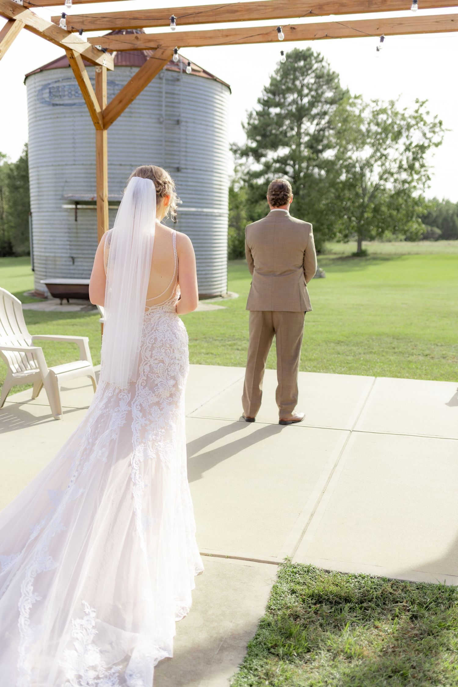 Groom first look with bride underneath the gazebo at Hilltop Acres Wicksburg, Alabama