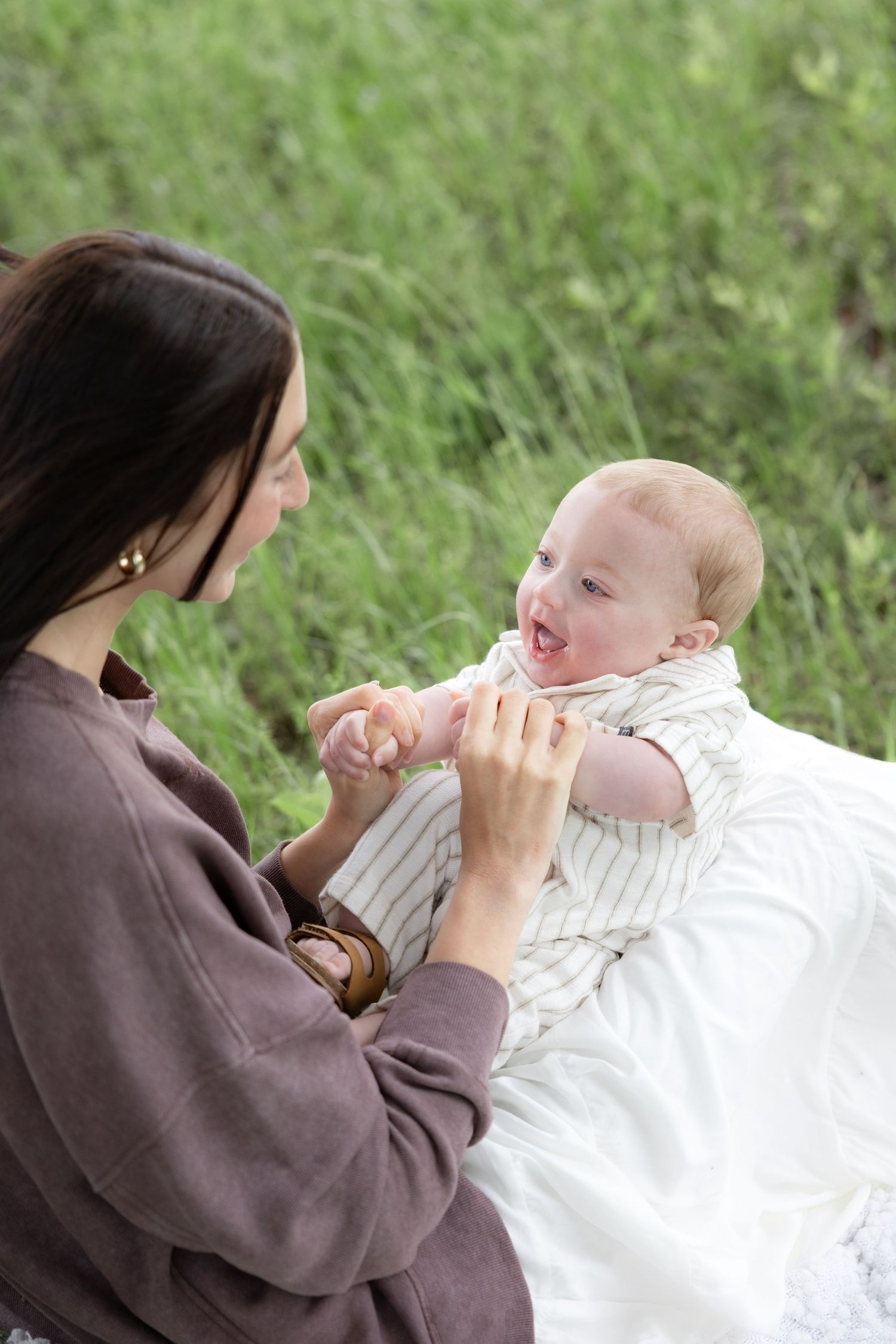 Candid family photos in a grass field | Dothan, Alabama Lifestyle Portrait Photographer