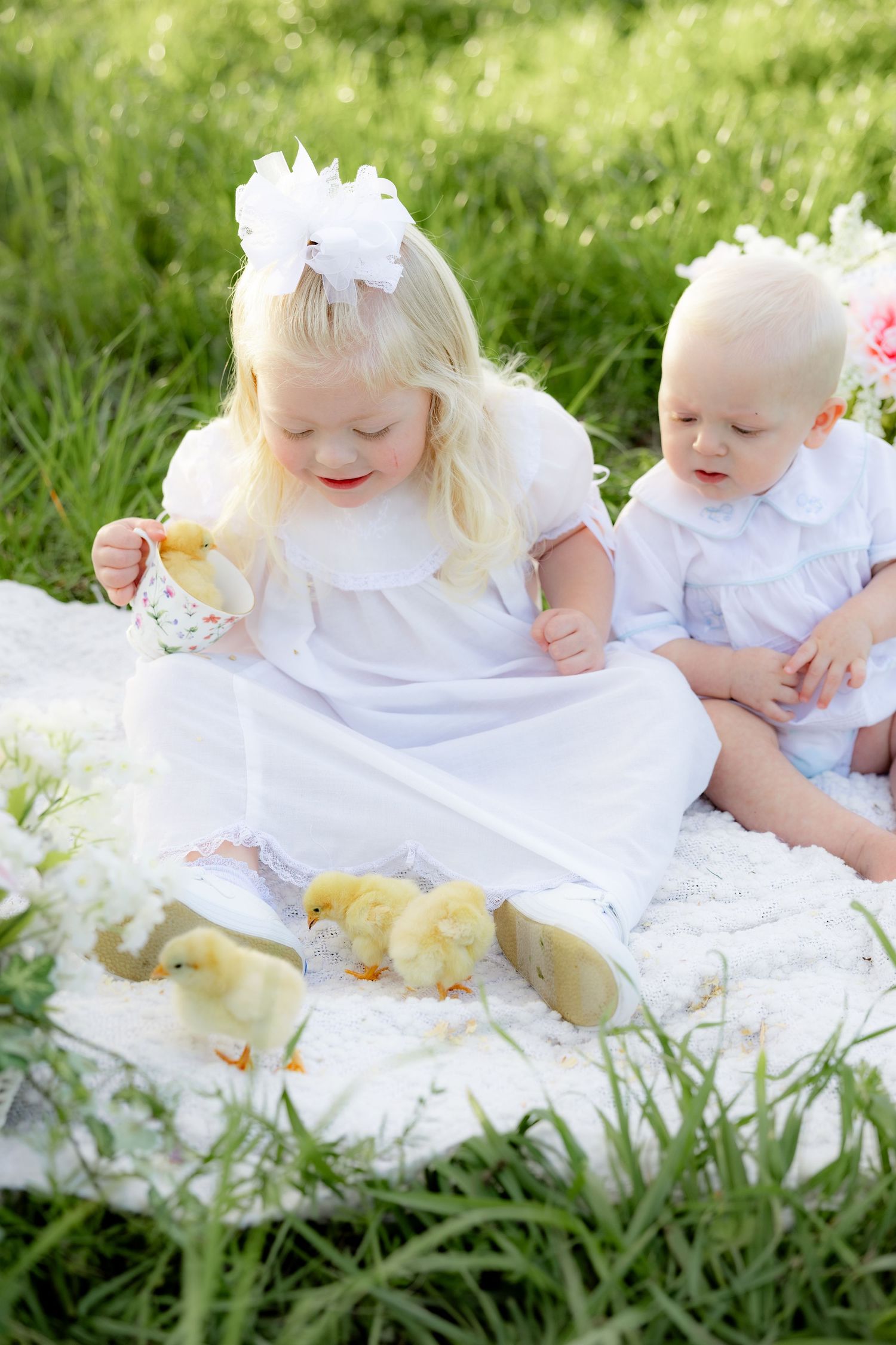 Spring Mini Session with baby chicks in a grass field at sunset near Dothan, Alabama