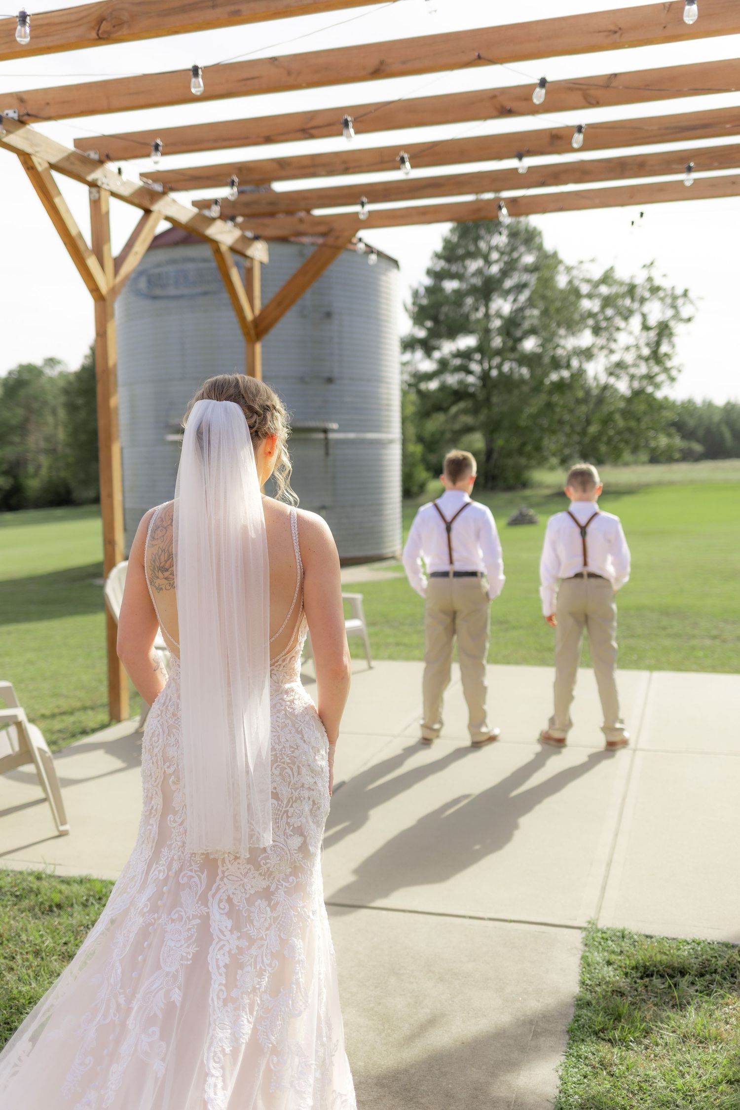 Sons' first look with bride underneath the gazebo at Hilltop Acres Wicksburg, Alabama