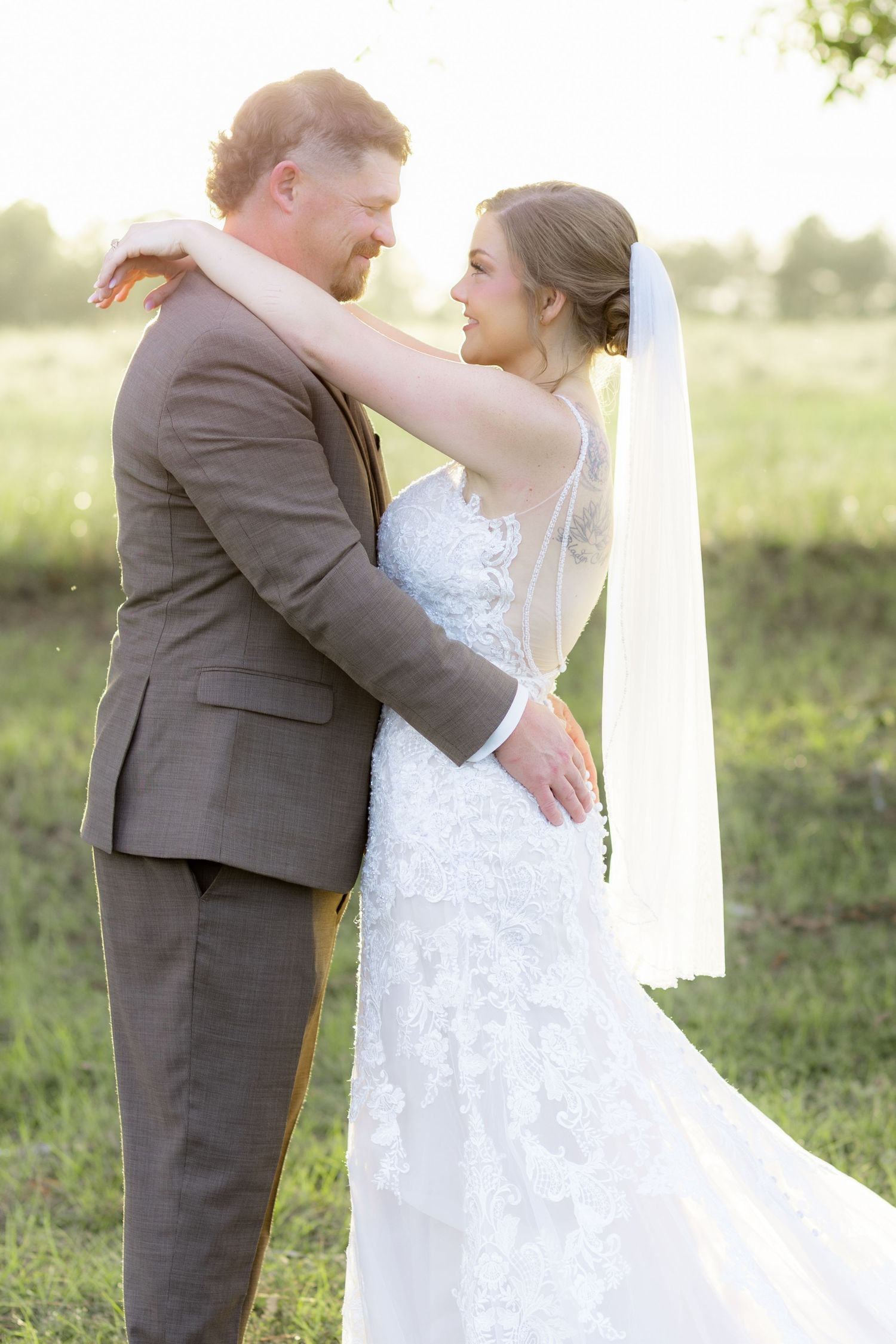 Bride and groom hold each other at sunset at Hilltop Acres Wicksburg, Alabama