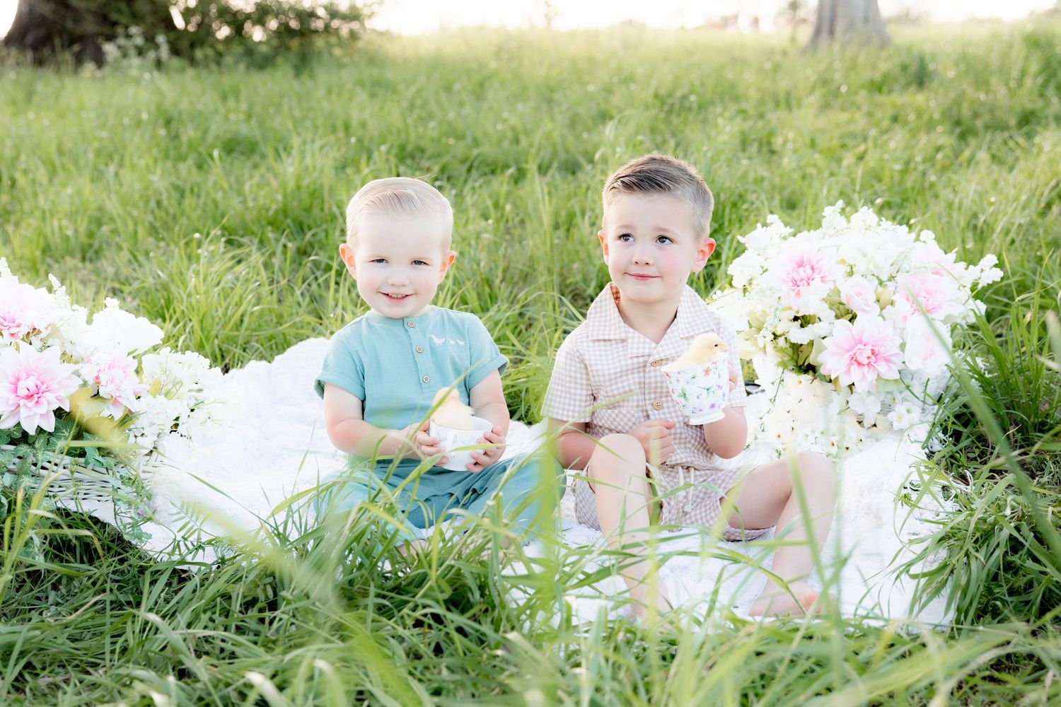 Spring Mini Session with baby chicks in a grass field at sunset near Dothan, Alabama