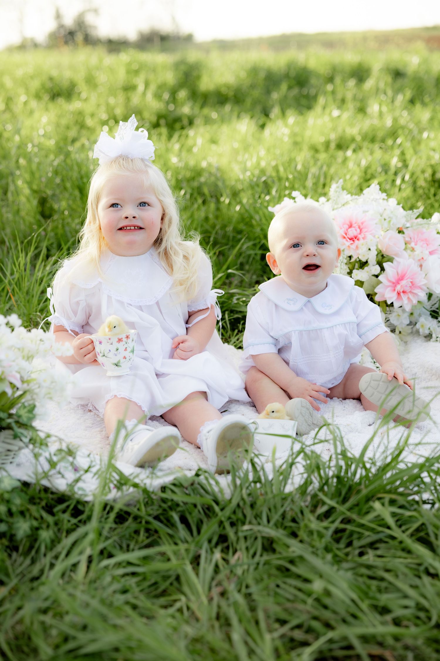 Spring Mini Session with baby chicks in a grass field at sunset near Dothan, Alabama