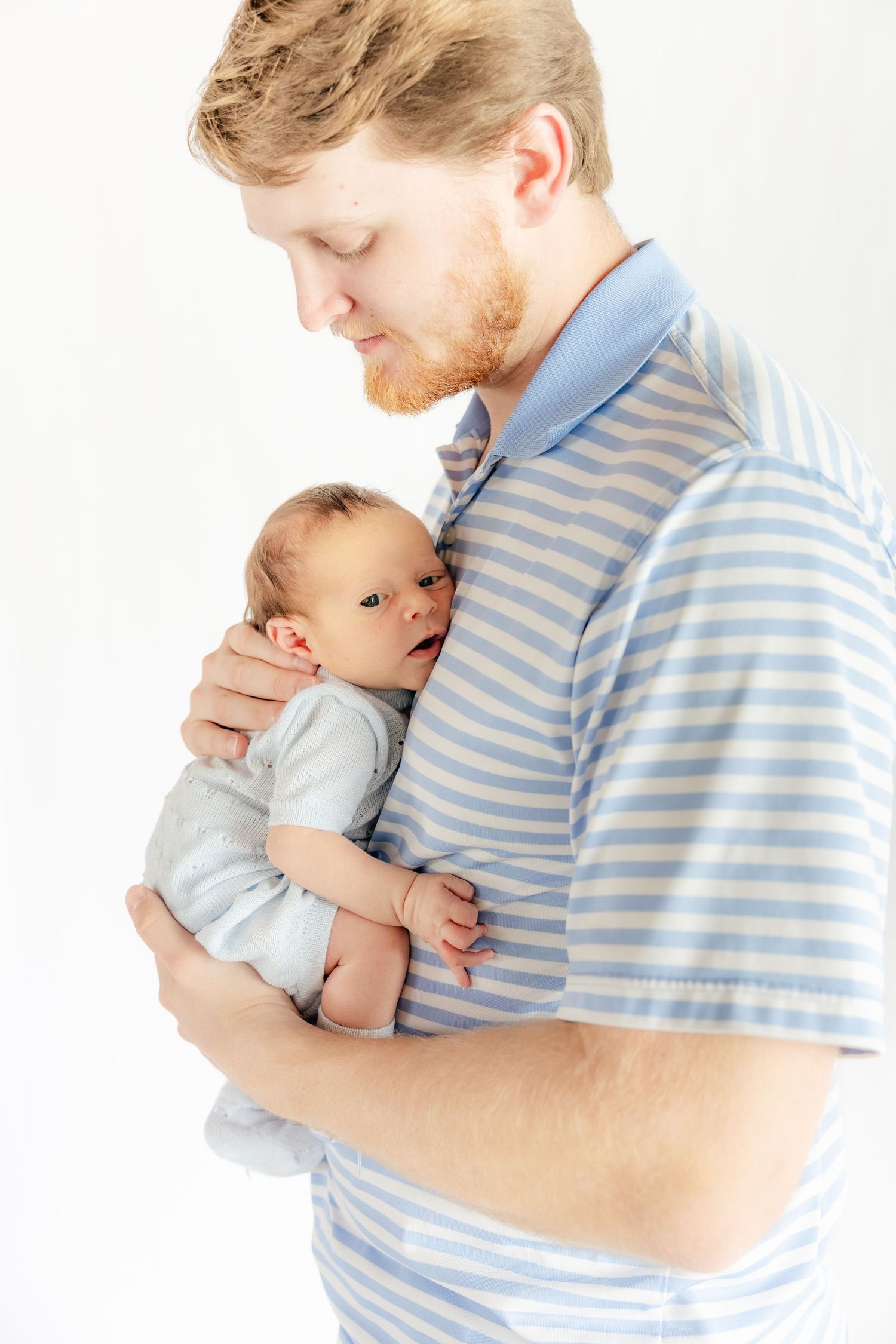 Father holding his baby in a studio in Dothan, Alabama
