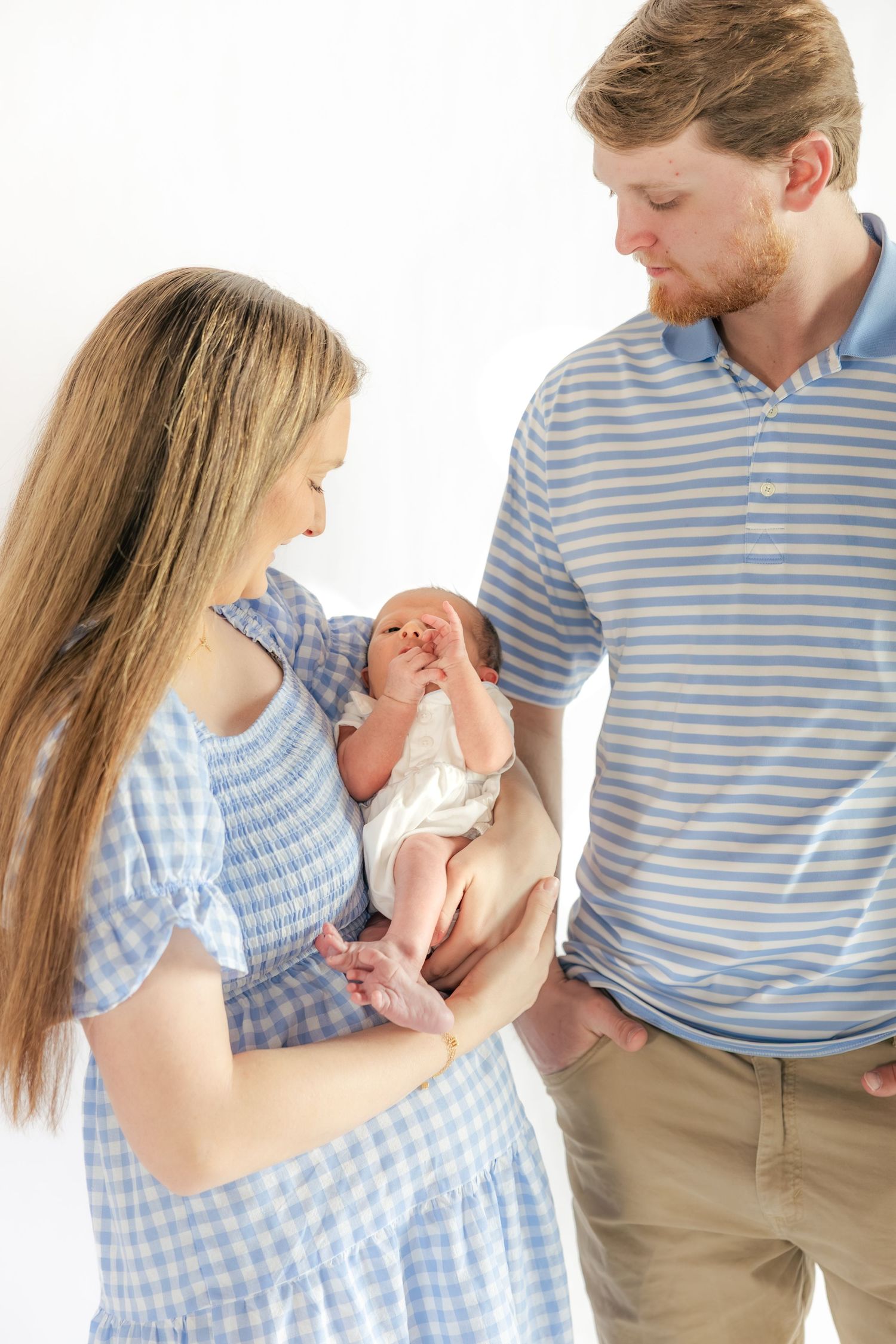 Family holding their newborn in a studio in Dothan, Alabama