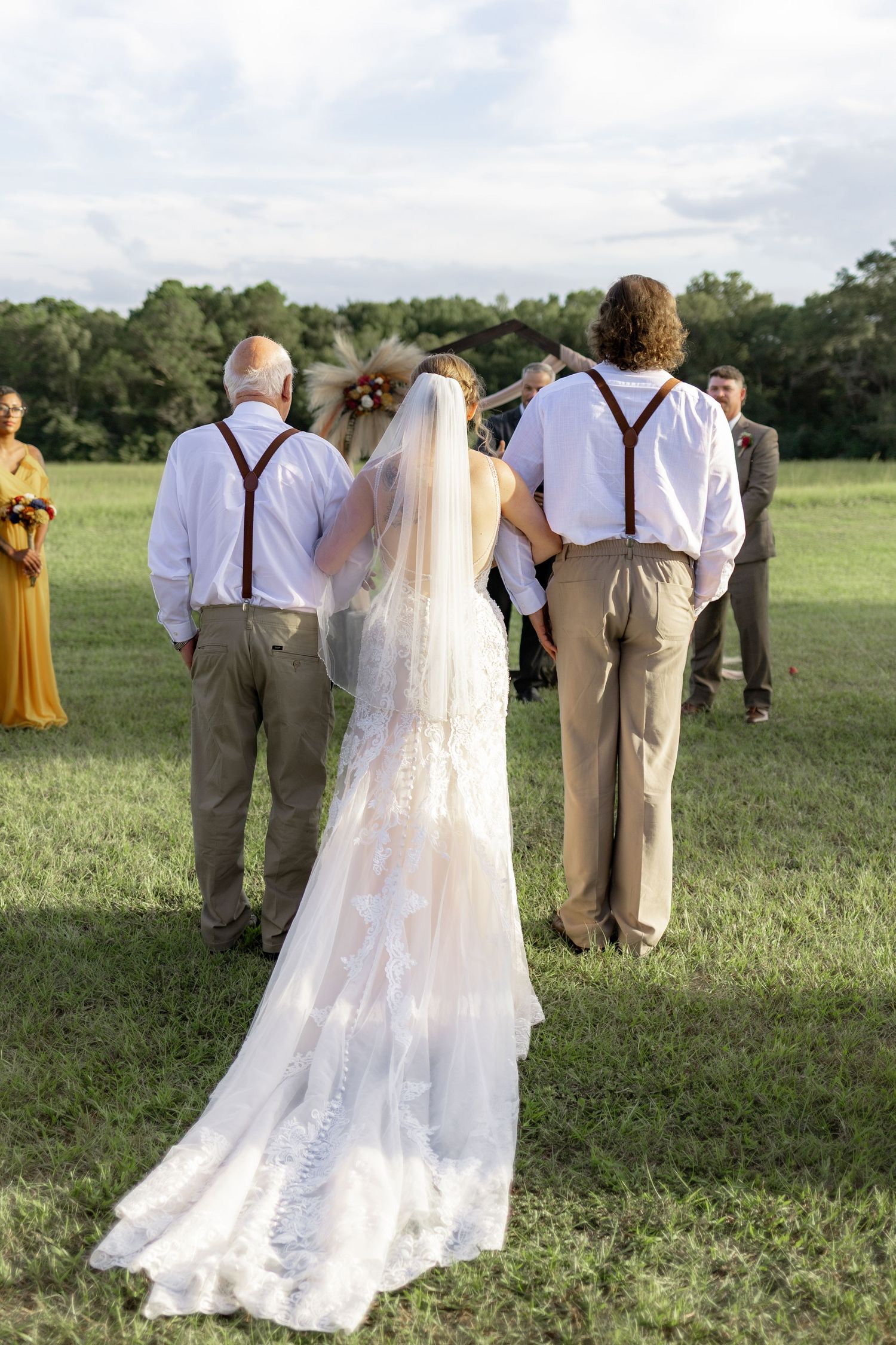 Father and brother giving the bride away at a wedding at Hilltop Acres Wicksburg, Alabama