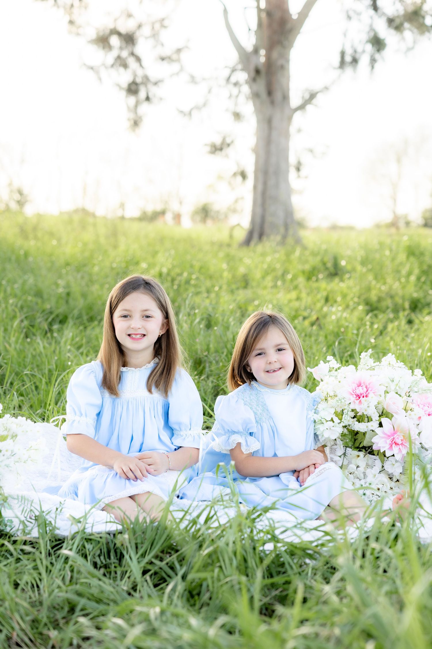Spring Mini Session with baby chicks in a grass field at sunset near Dothan, Alabama