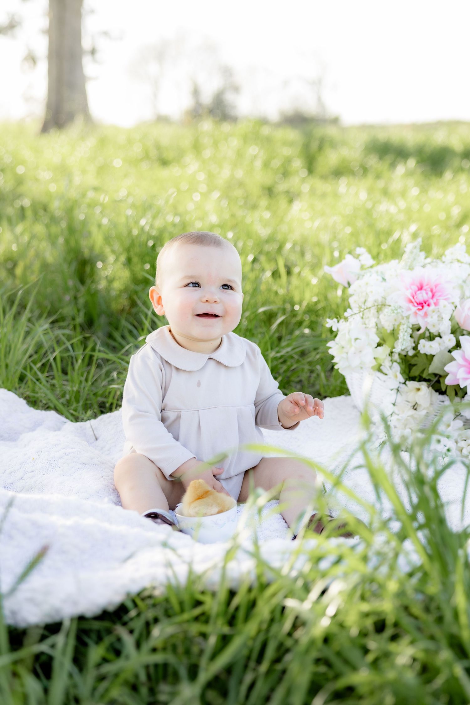 Spring Mini Session with baby chicks in a grass field at sunset near Dothan, Alabama
