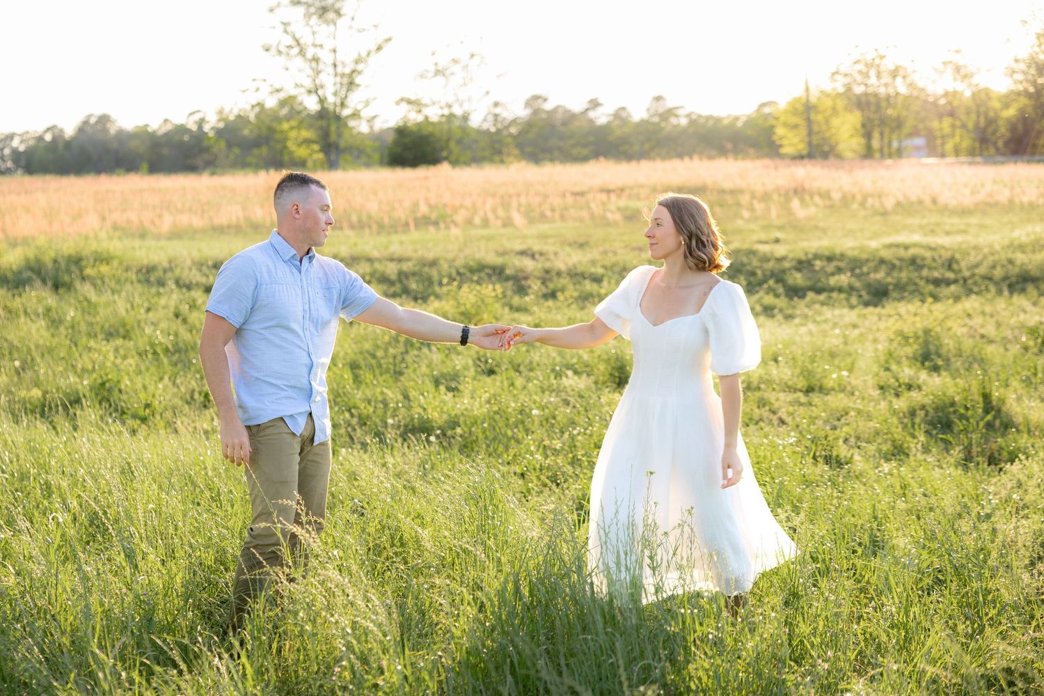 Storytelling couple photos in a tall grass field at sunset in Dothan, Alabama
