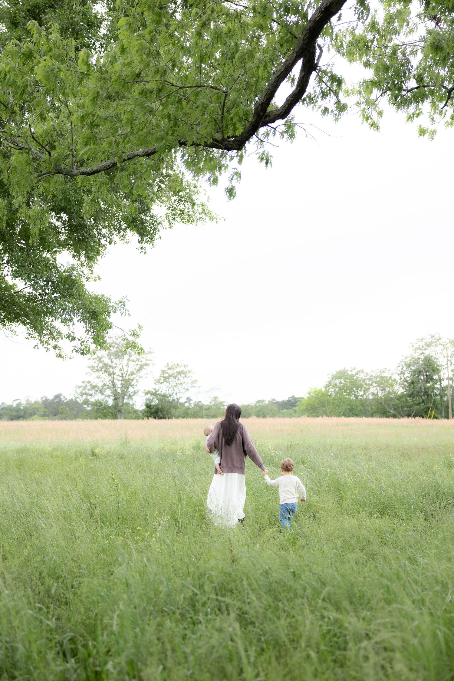 Candid family photos in a grass field | Dothan, Alabama Lifestyle Portrait Photographer