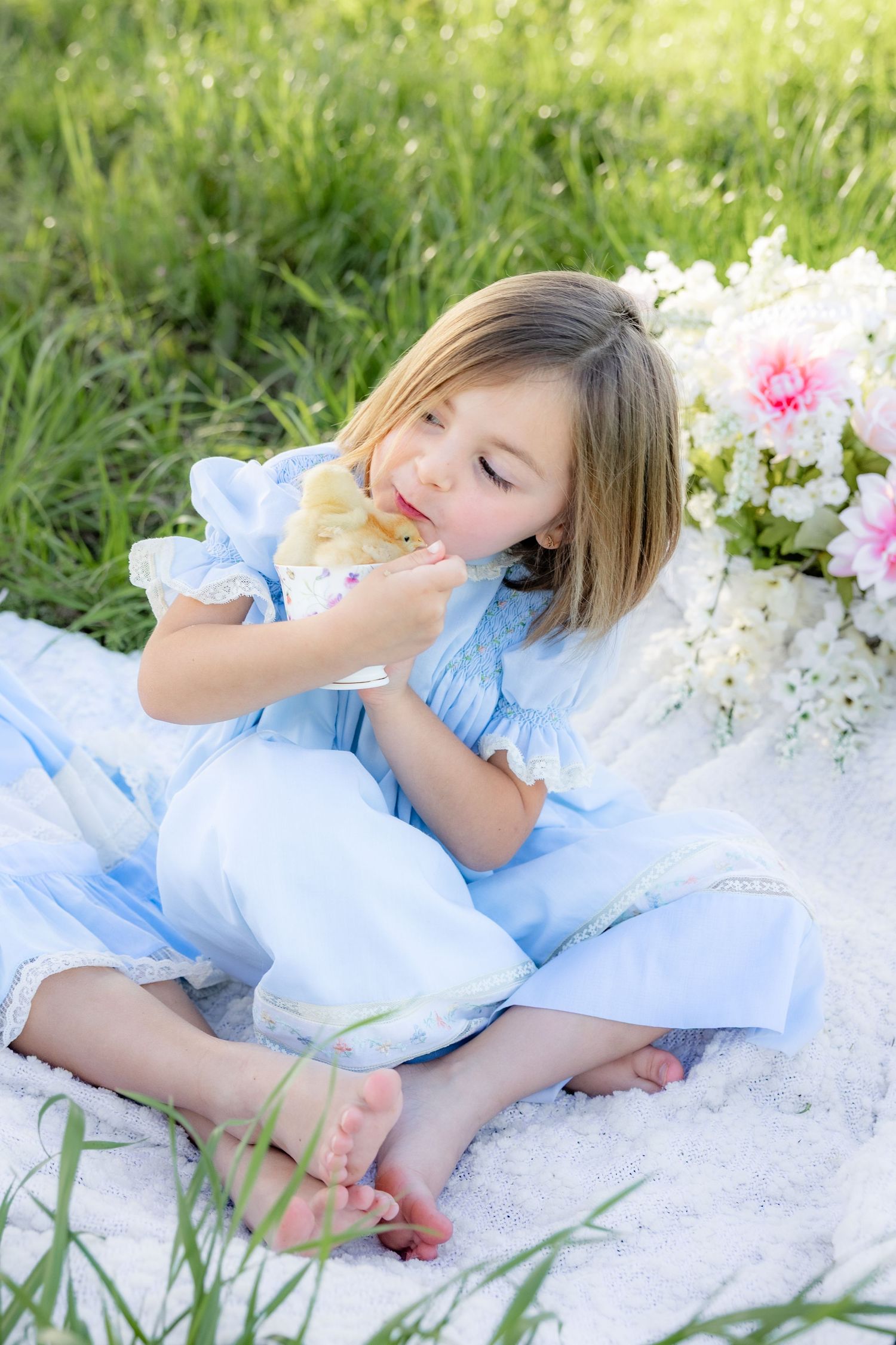 Spring Mini Session with baby chicks in a grass field at sunset near Dothan, Alabama