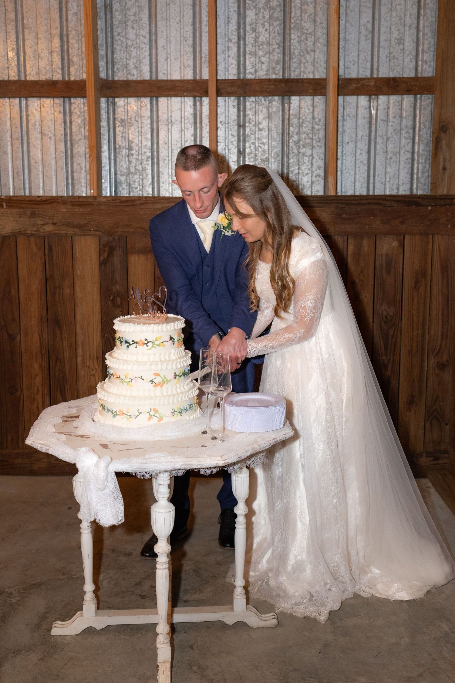 Bride and groom cut cake at their reception at Dalrymple Farms Enterprise, Alabama