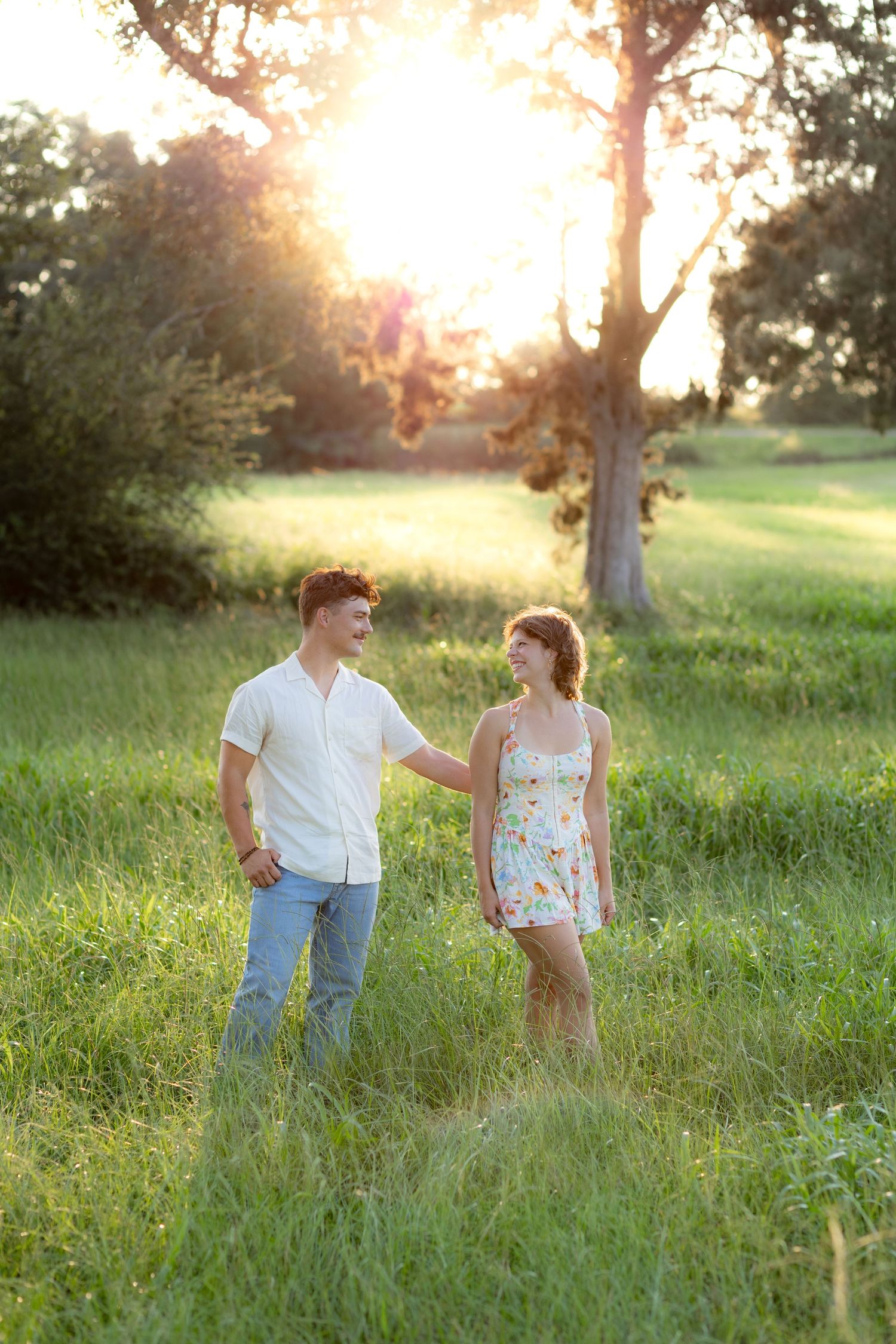 Couple standing in a grass field in Dothan Alabama