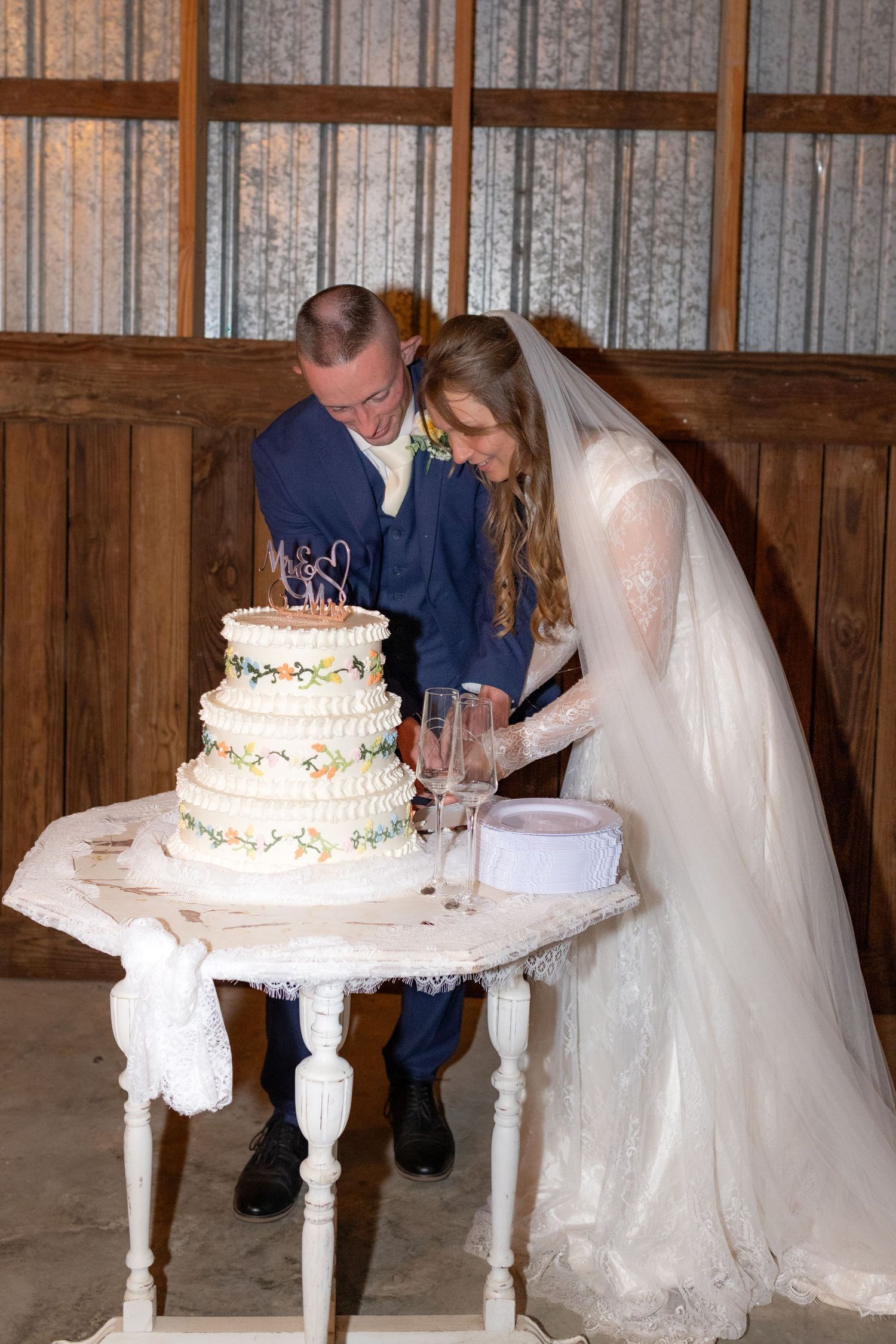 Bride and groom cut cake at their reception at Dalrymple Farms Enterprise, Alabama